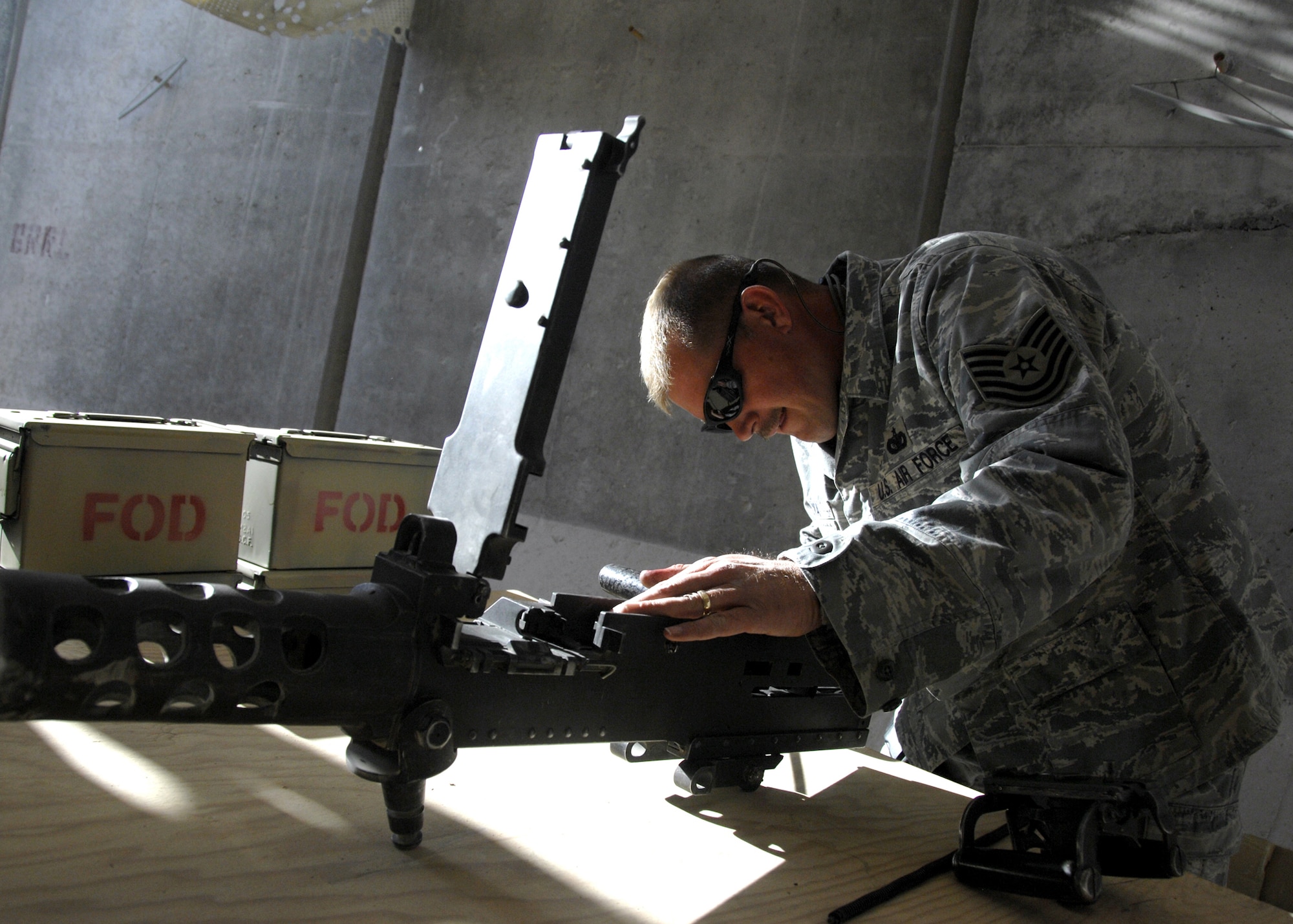 KANDAHAR AIRFIELD, Afghanistan — Tech. Sgt. Stephen Vermilya cleans a 50-caliber machine gun, Dec. 5, 2009. Cleaning a weapon is just as important as knowing how to use one. Sergeant Vermilya is a combat arms instructor with the 451st Expeditionary Security Forces Squadron from Mountain Home Air Force Base, Idaho. (U.S. Air Force photo/Senior Airman Timothy Taylor)
