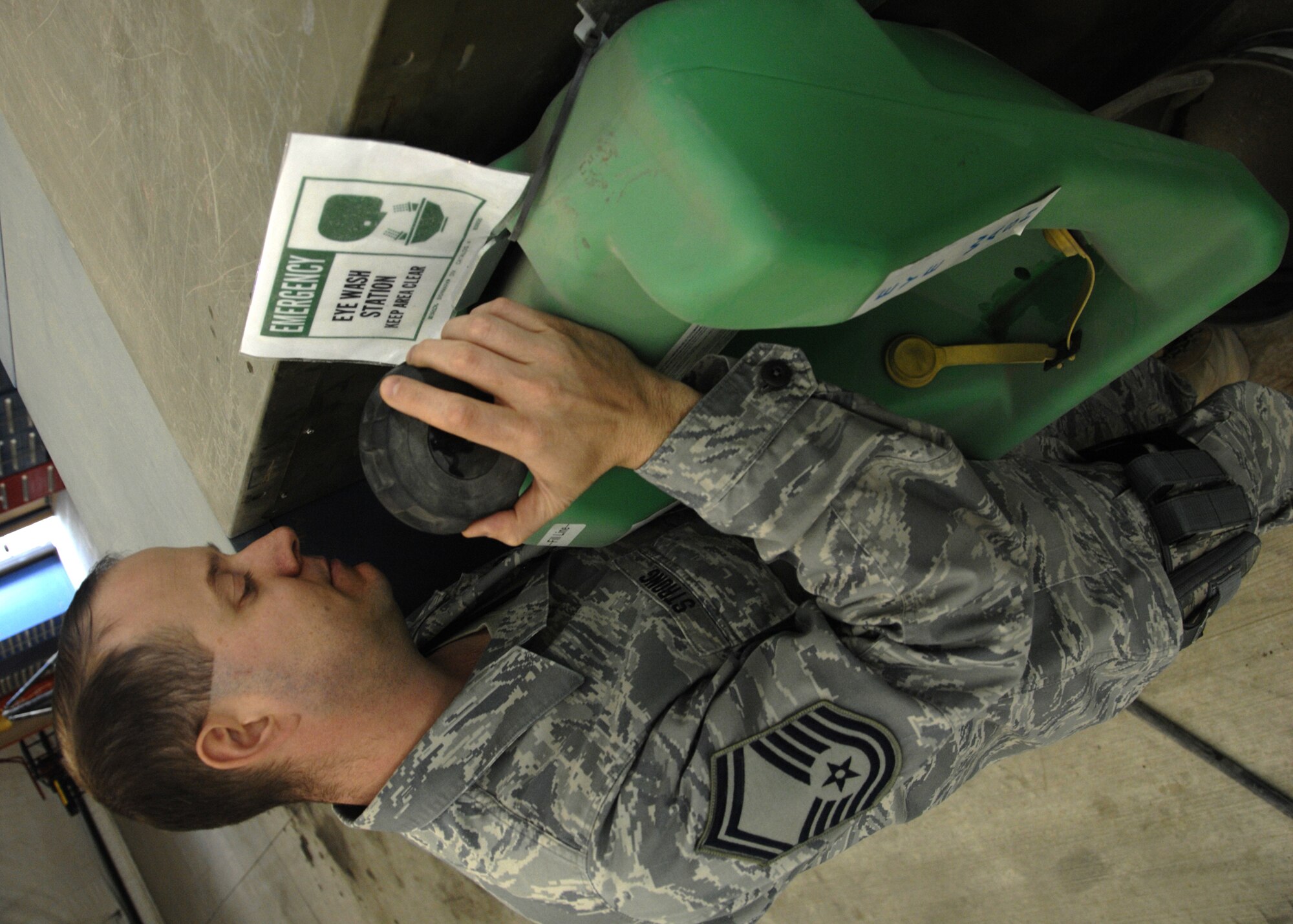 KANDAHAR AIRFIELD, Afghanistan -- Senior Master Sgt. Bruce Strong, Jr., inspects an eyewash station to ensure all standards are being met Dec. 5, 2009. It is important to make sure all eyewash stations are serviceable in case an emergency arises. Sergeant Strong is a Ground Safety Manager for the Air National Guard in Maryland. (U.S. Air Force photo/Senior Airman Timothy Taylor)