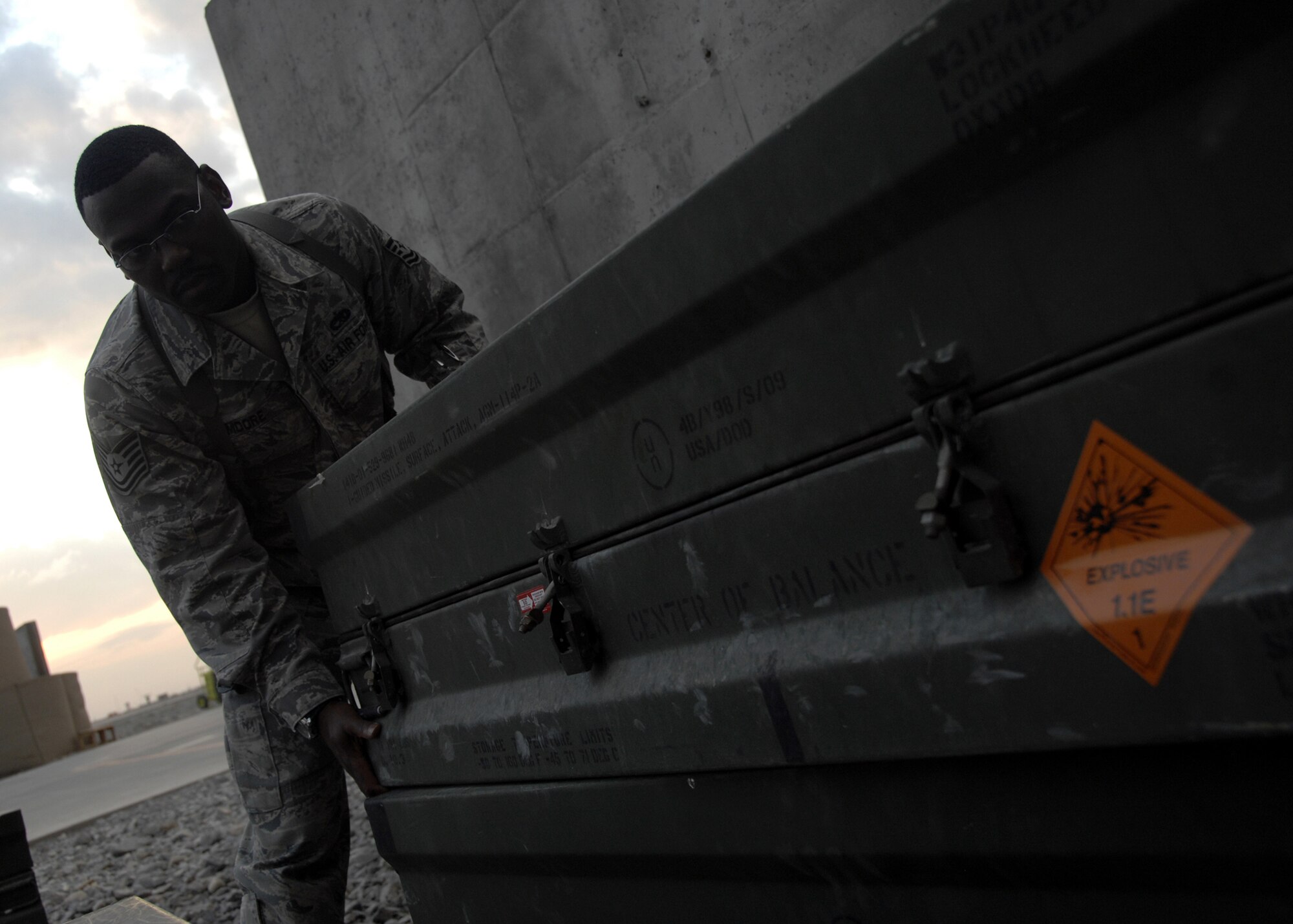 KANDAHAR AIRFIELD, Afghanistan -- Tech. Sgt. Anthony Moore monitors net explosive weights during a spot inspection on the flightline Dec. 3, 2009. Inspecting N.E.W. is the primary way to ensure there is a minimum risk to personnel, equipment, and assets while meeting mission requirements. Sergeant Moore is a Weapons Safety Manager for the 451st Safety Office from Langley Air Force Base, Va. (U.S. Air Force photo/Senior Airman Timothy Taylor)