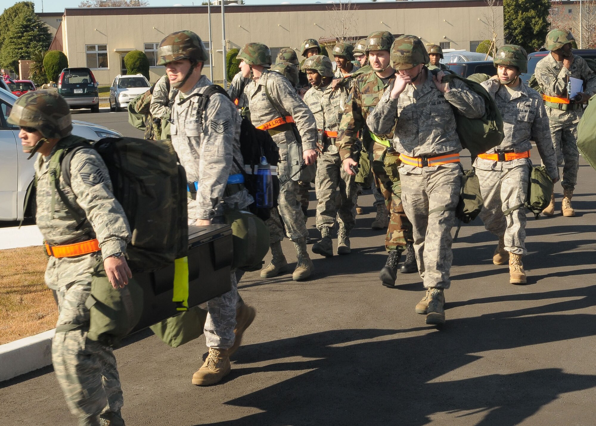 YOKOTA AIR BASE, Japan -- Airmen from the 374th Airlift Wing transport mission essential gear during a building evacuation Dec. 7 during an operational readiness inspection conducted by the Pacific Air Forces Inspector General. (U.S. Air Force photo/Airman 1st Class Sean Martin)