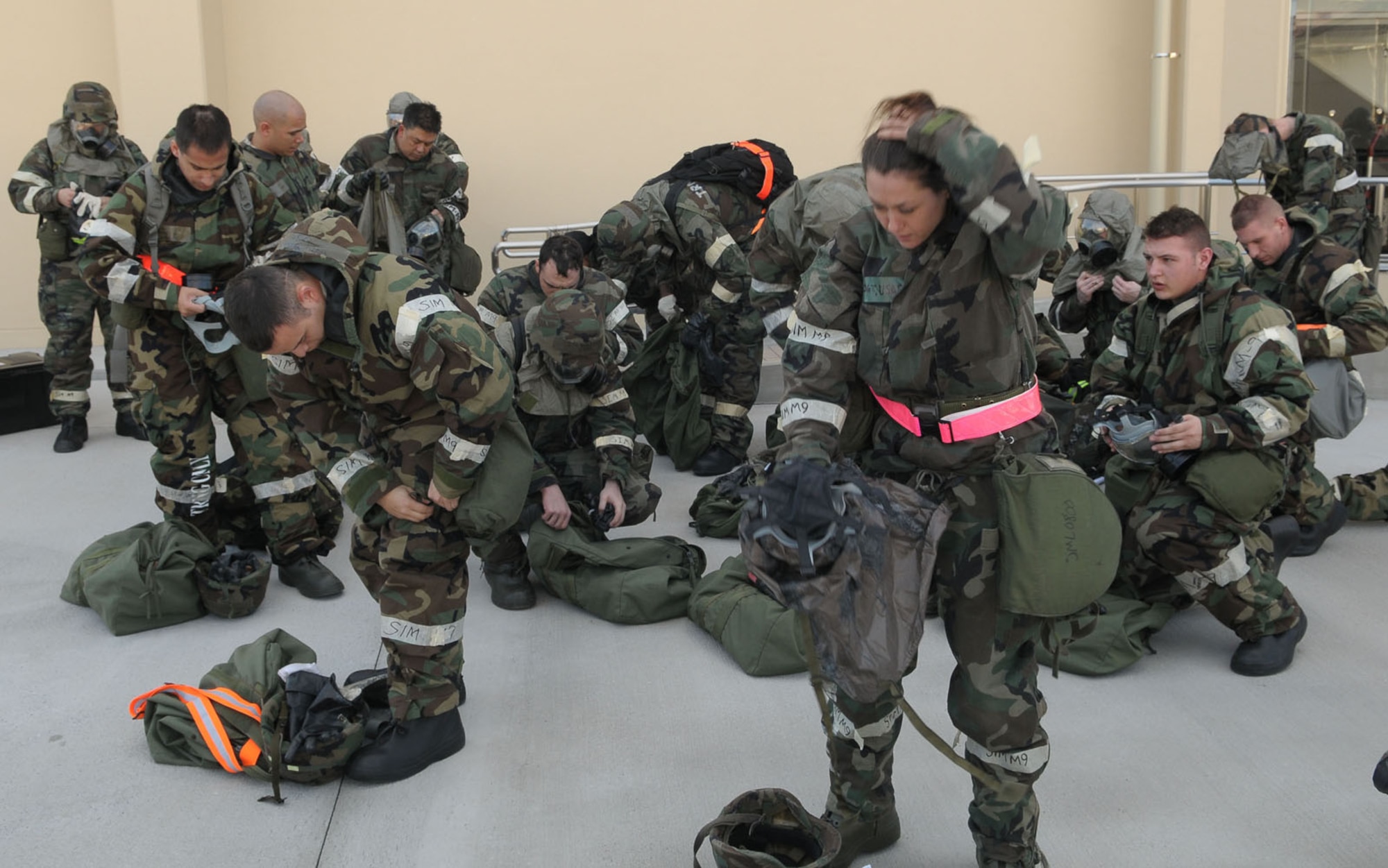 YOKOTA AIR BASE, Japan -- Airmen from the 374th Airlift Wing remove their chemical defense ensembles Dec. 7 during an operational readiness inspection conducted by the Pacific Air Forces Inspector General. The Airmen, forced to evacuate their primary duty location, were evaluated on their bug-out and accountability procedures. (U.S. Air Force photo/Airman 1st Class Sean Martin)