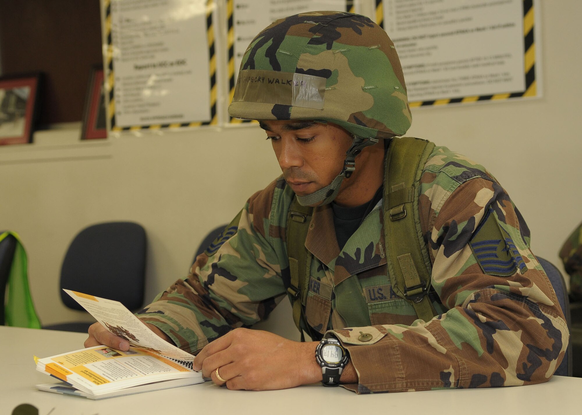 YOKOTA AIR BASE, Japan -- Master Sgt. Gregory Walker, 374th Airlift Wing, studies his Airman's Manual Dec. 7 during an operational readiness inspection conducted by the Pacific Air Forces Inspector General.  The Airman's Manual contains information on surviving and operating during hostilities and is a reference for use in contingency operations. (U.S. Air Force photo/Airman 1st Class Sean Martin)