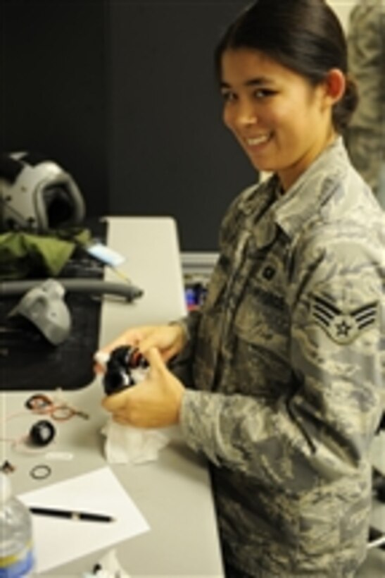 U.S. Air Force Senior Airman Jaime Williams, with the 437th Operations Support Squadron, inspects parts of a mouthpiece on a flyer's helmet at Charleston Air Force Base, S.C., on Dec. 1, 2009.  The squadron provides life support equipment to airmen with the 437th and 315th Airlift Wings.  