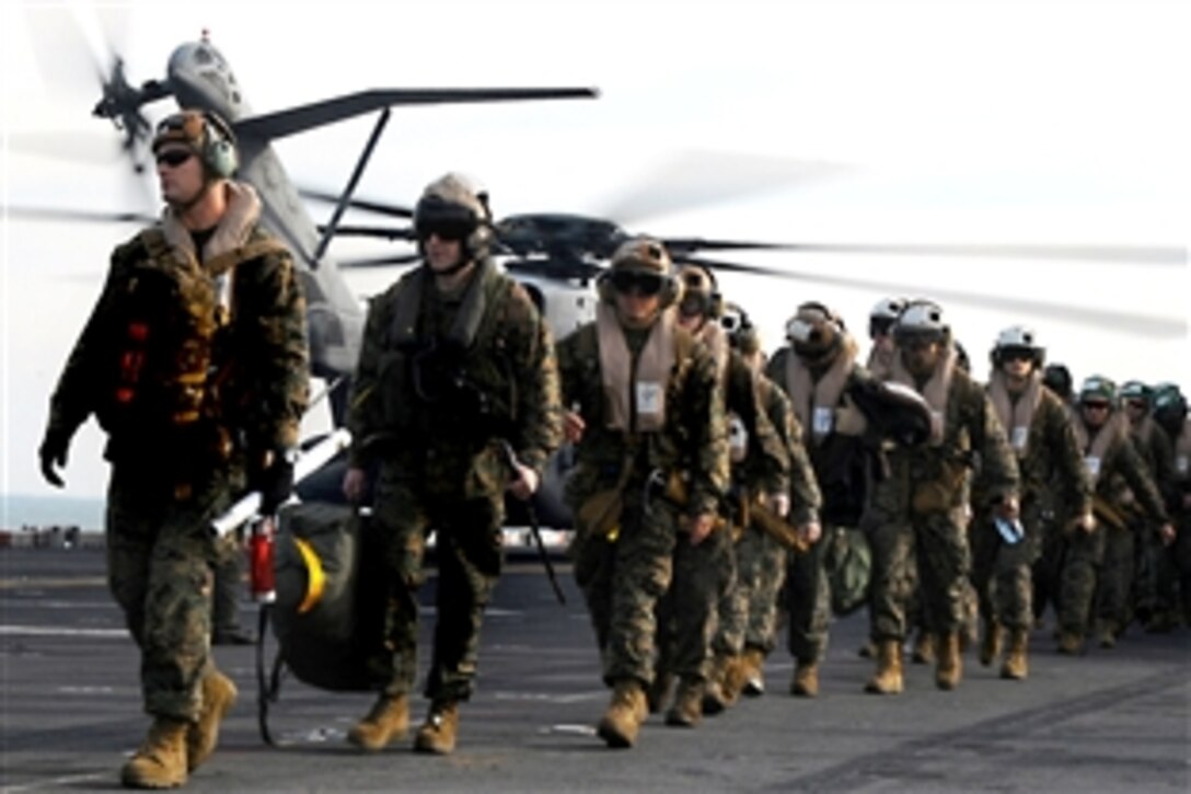 U.S. Marines prepare to depart the USS Bataan after completing a seven-month deployment with the Bataan Amphibious Ready Group, Onslow Bay, N.C., Dec. 4, 2009. The Marines are assigned to the 22nd Marine Expeditionary Unit.