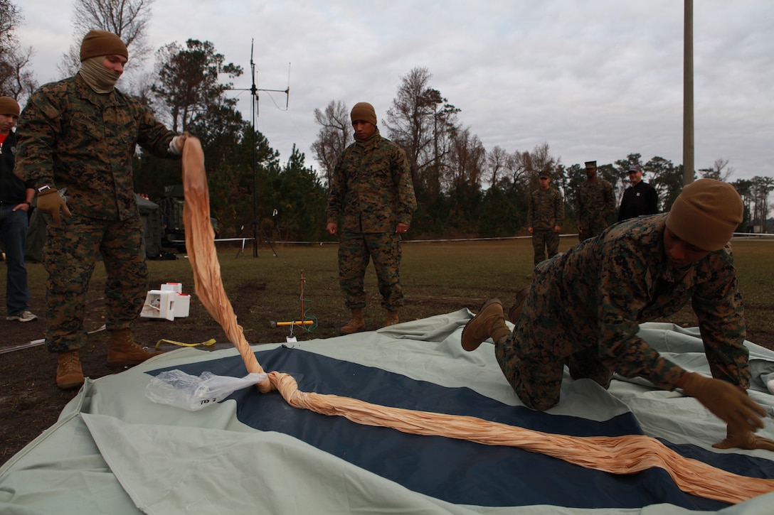 Cpl. Kenneth Vandame and Sgt. Lester Ward from 26th Marine Expeditionary Unit spreads out the balloon portion of the Combat SkySat High Altitude Operations Payload system during a lofted communications exercise aboard Camp Lejeune, NC, Dec . 8, 2009. By floating relay equipment on a balloon, SkySat can extend the range of military radios from four miles up to hundreds of miles. (Official Marine Corps photo by Sgt. Danielle M. Bacon)::r::::n:: ::r::::n::