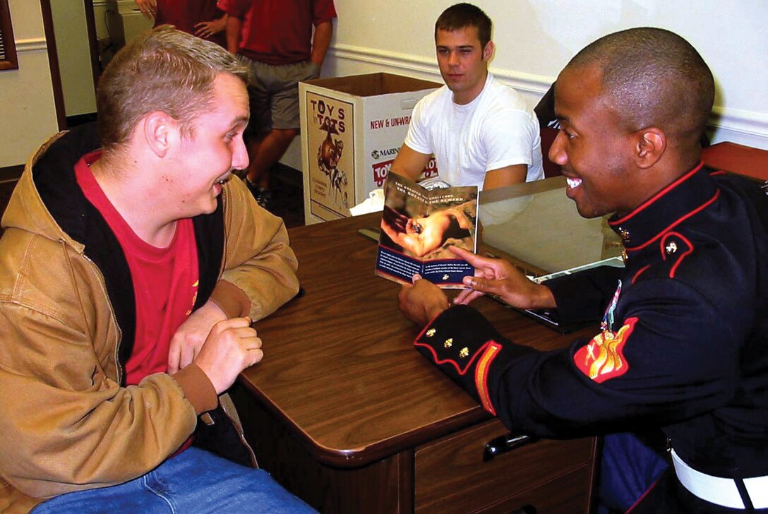 Dustin Miller, a poolee out of Recruiting Sub-station Frederick, Md., talks with his recruiter, Sgt. Charles Jones, about his future.