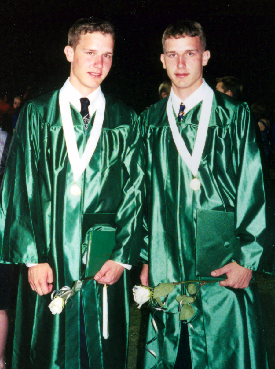 BURNET, Texas - Justin Lewis (left) and his twin brother, Jason, pose for a photo at their high school graduation from Burnet High School in 2001. The two went on to attend Concordia University in Austin and are now achieving their dreams of becoming police officers through the United States Marine Corps. (Courtesy Photo)