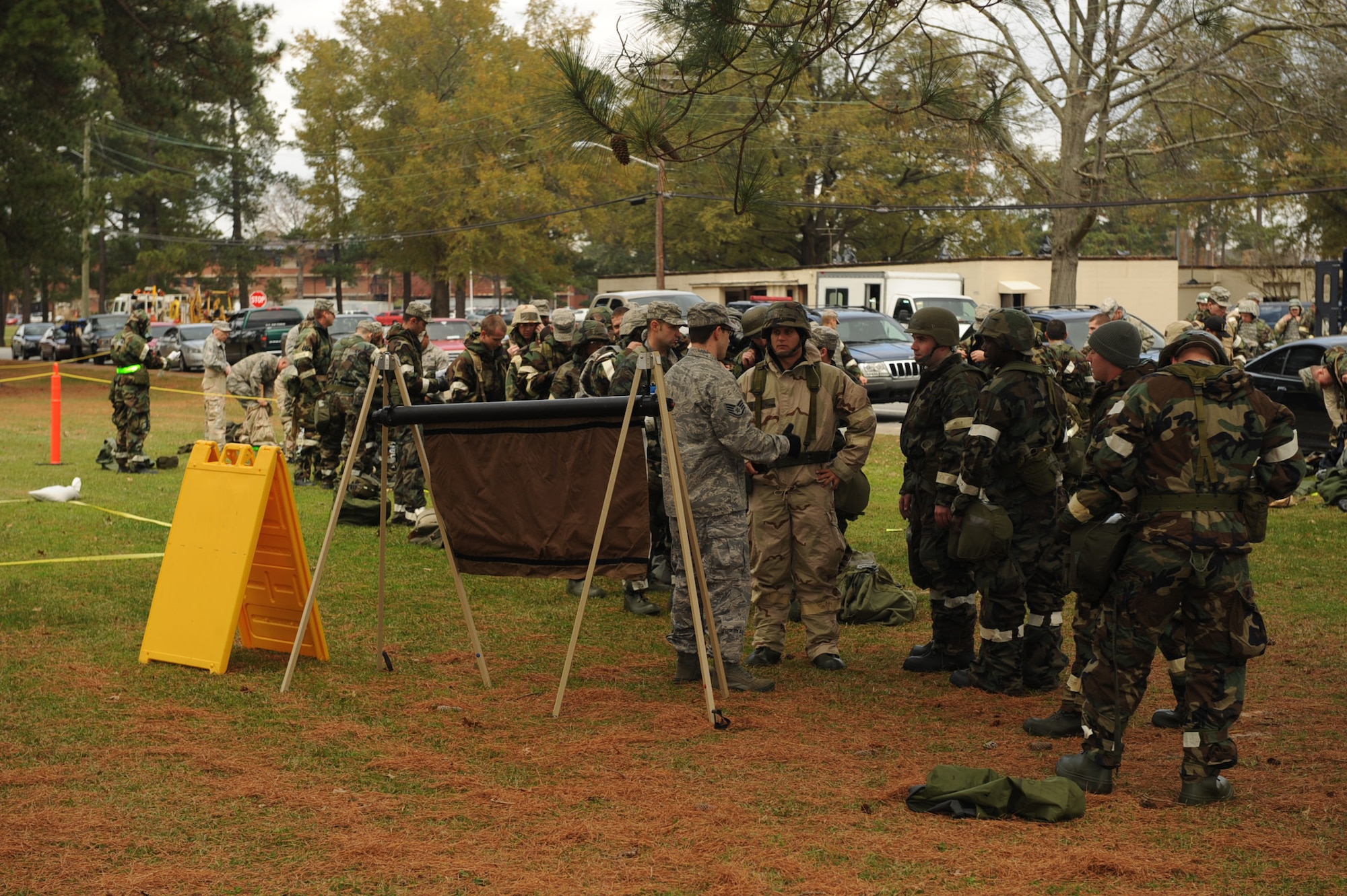 Airmen wait in line to go through the contamination control area on Seymour Johnson Air Force Base, N.C., Dec. 7, 2009. Removing contaminated equipment is a task completed in the CCA by going through a set-by-step process of removing equipment. (U.S. Air Force photo/Senior Airman Ciara Wymbs)