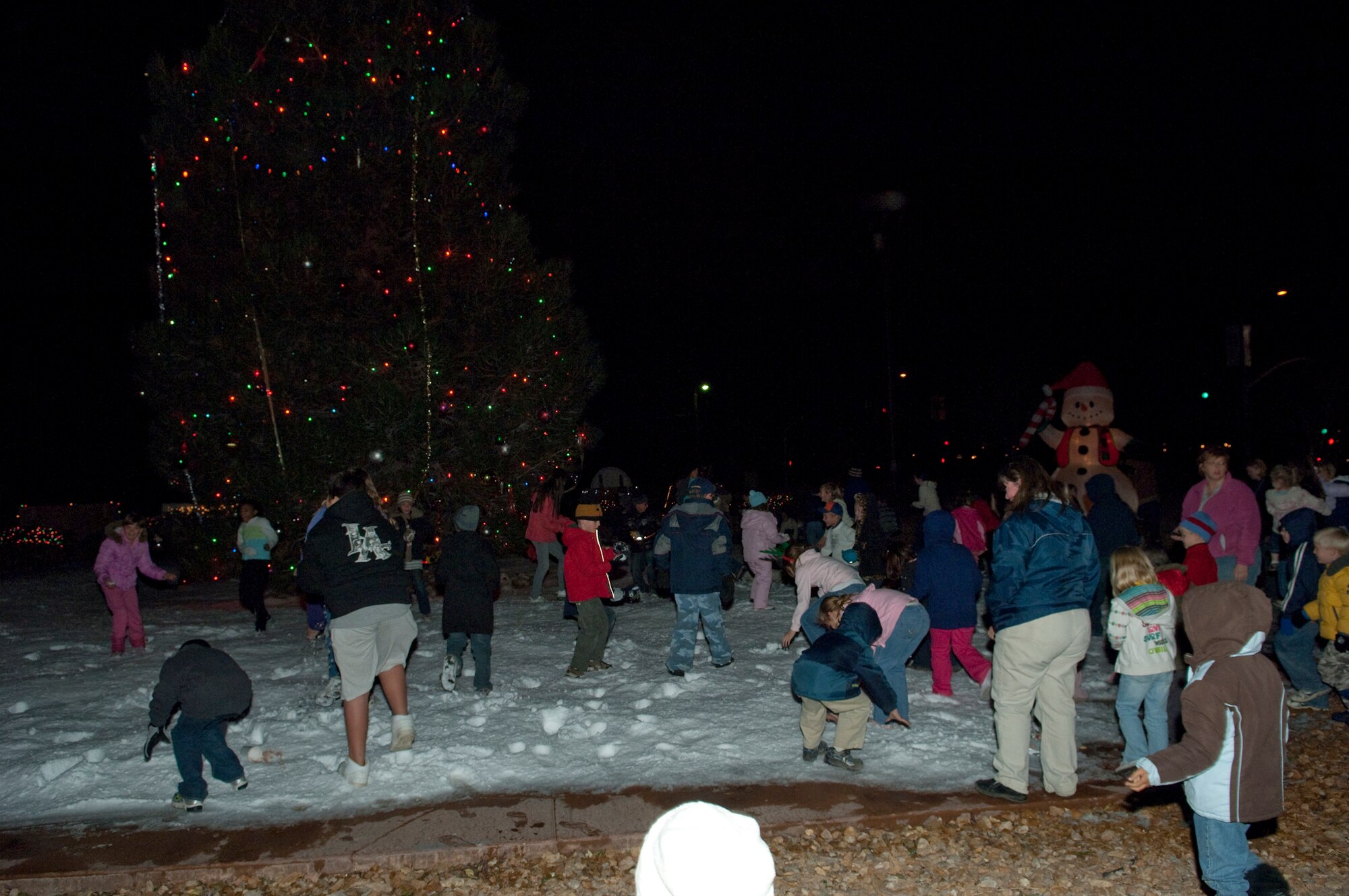 Edwards children play underneath the Holiday Tree during the 13th annual Tree Lighting ceremony Dec. 2 at the Base Exchange parking lot. The festivity marks the beginning of the holiday season at Edwards. (U.S. Air Force photo/Michael Yncera)
