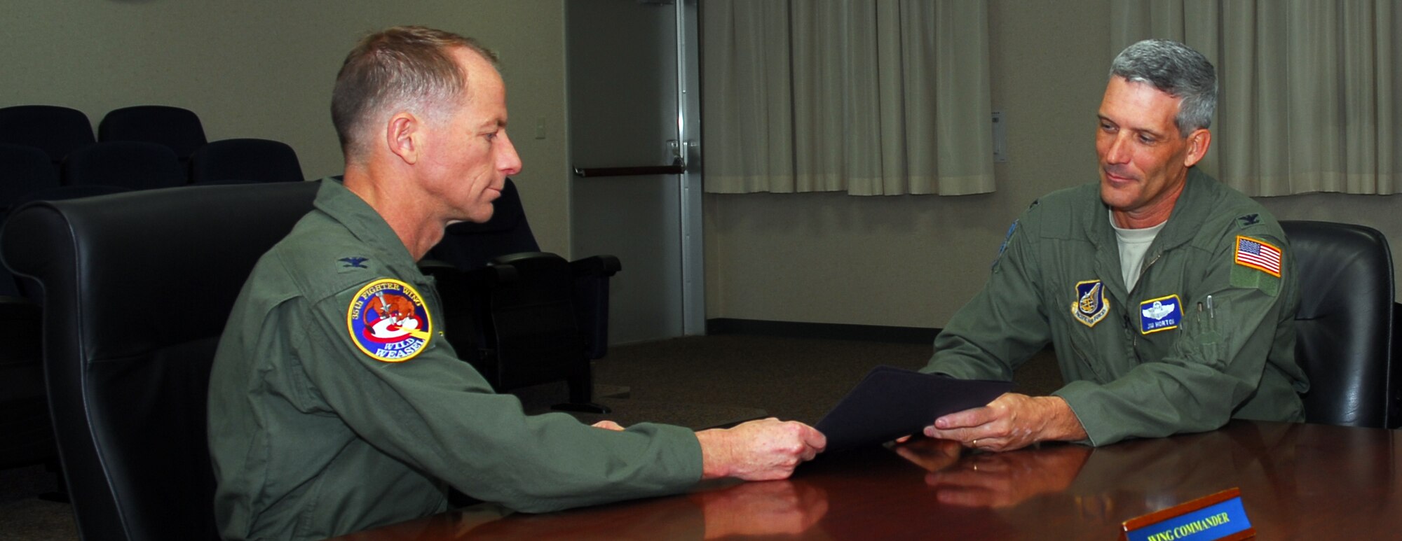 MISAWA AIR BASE, Japan— Col. James Horton, Pacific Air Forces Inspector General chief, gives Col. David Stilwell, 35th Fighter Wing commander, the PACAF IG unit compliance inspection report Dec. 4 in the 35th FW conference room. During the IG’s no-notice visit, five units were inspected; four of the five units received a satisfactory rating, with the 14th Fighter Squadron garnering an outstanding. (U.S. Air Force photo/Staff Sgt. Phillip Butterfield)
