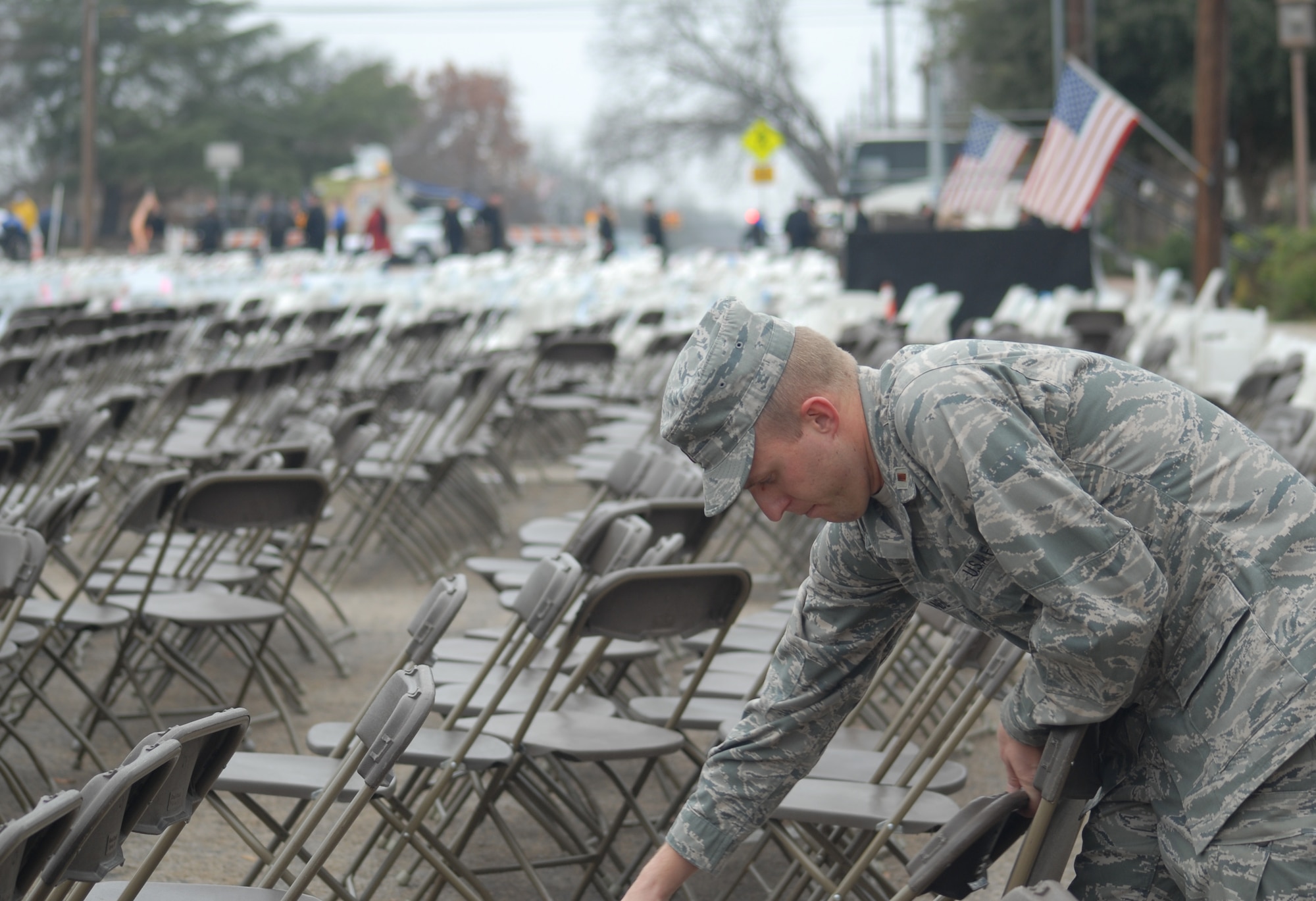 2nd Lt. Chad Brandl, 315th Training Squadron, Goodfellow AFB, Texas helps take down over 4,000 chairs for the grand opening ceremony of the George H.W. Bush Gallery of the War in the Pacific Museum, Fredericksburg on Dec. 7.  80 volunteers of Soldiers, Sailors, Airman and Marines from Goodfellow travelled 150 miles to help with the opening of the museum expansion, providing chair set-up and tear down, distinguished guests escort and led tours of the new facility.  The former President George H.W. Bush, attended as well as Rick Perry, Governor of Texas.  Over 4,000 people were in attendance.  (U.S. Air Force photo by/Robert D. Martinez)