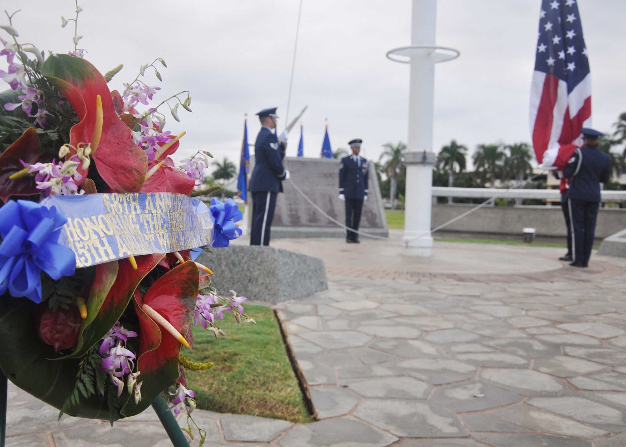 The Hickam Air Force Base honor guard prepares to raise the U.S. flag at Hickam AFB during the ceremony Dec. 7, 2009, that marked the anniversary of the Dec. 7, 1941, attacks on Pearl Harbor Navy fleet and the Army Air Corps fields of Hickam, Wheeler and Bellows. Survivors and their families from the infamous day were on hand to pay tribute to their lost brothers and sisters in arms. Wreaths and tokens of honor were laid at the base of the memorial at Atterbury Circle. (U.S. Air Force photo/Staff Sgt. Mike Meares)
