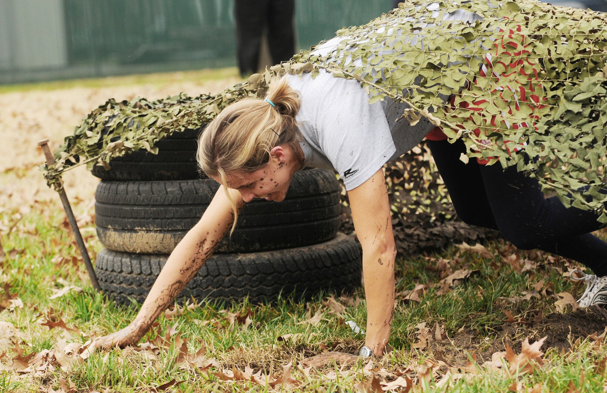 Team Black member Adrienne Mason crawls out of the low-crawl obstacle during an  obstacle course competition Dec. 4, 2009 on Bolling Air Force Base, D.C. (U.S. Air Force photo/Senior Airman Sean Adams)