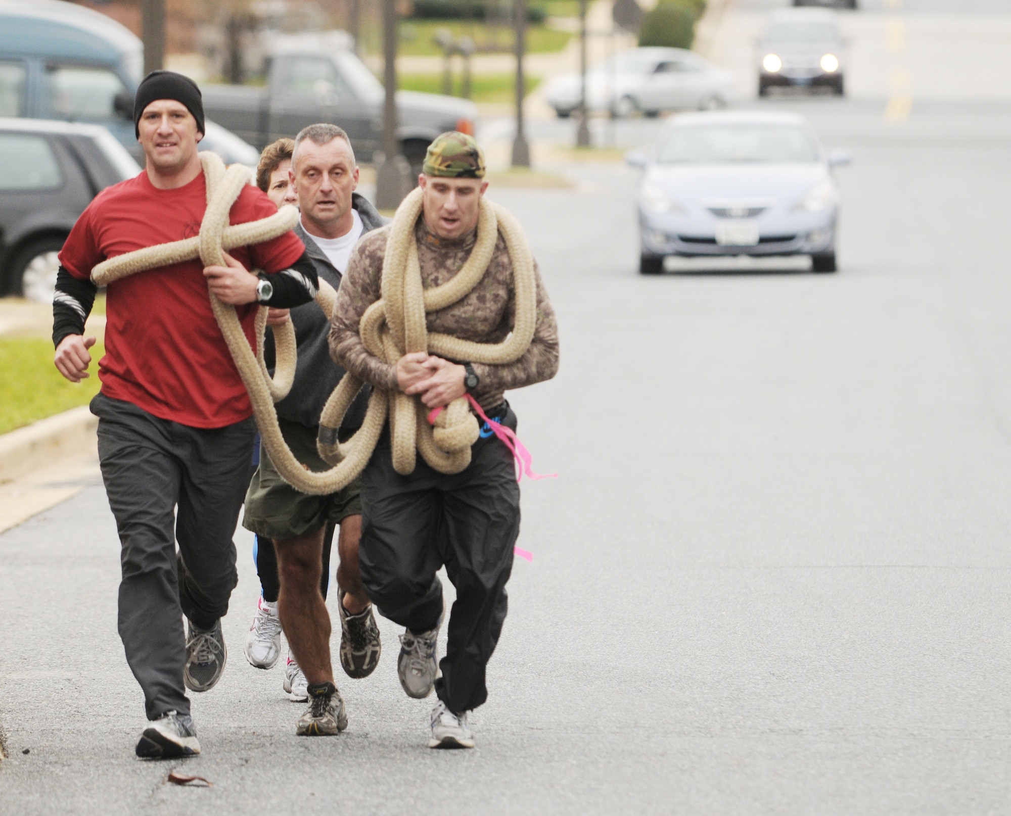 Team Purple members carry a rope uphill during an obstacle course competition Dec. 4, 2009 on Bolling Air Force Base, D.C. Team Purple came in first across the finish line at 1 hour and 3 minutes. (U.S. Air Force photo/Senior Airman Sean Adams)