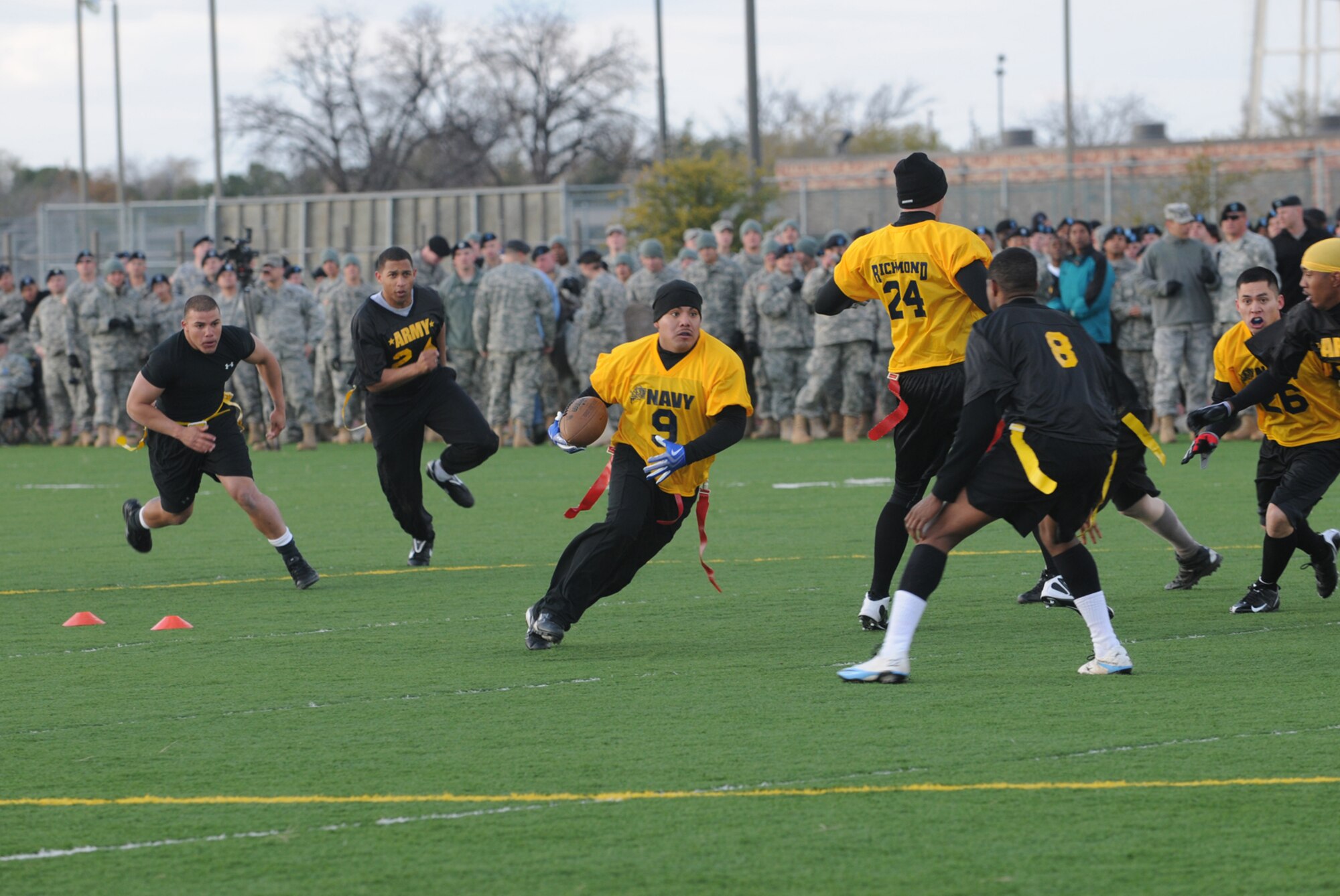 GOODFELLOW AIR FORCE BASE, Texas -- A Navy player rushes past Army defenders during the Army-Navy Football Game, Dec. 4, 2009. Army took home the win, 20-8. (U.S. Air Force photo/Airman Clayton Lenhardt)