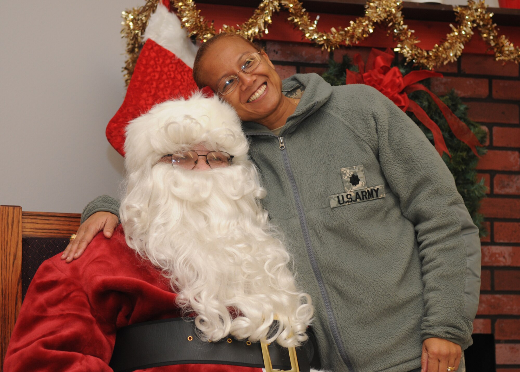 GOODFELLOW AIR FORCE BASE, Texas -- Lt. Col. Bichson Bush, 344th Military Intelligence Battalion commander, gets her photo taken with Santa Claus after the tree lighting ceremony, Dec. 7, 2009. Anyone who had their picture taken with Santa received a Polaroid to take home. (U.S. Air Force photo/Airman Clayton Lenhardt)