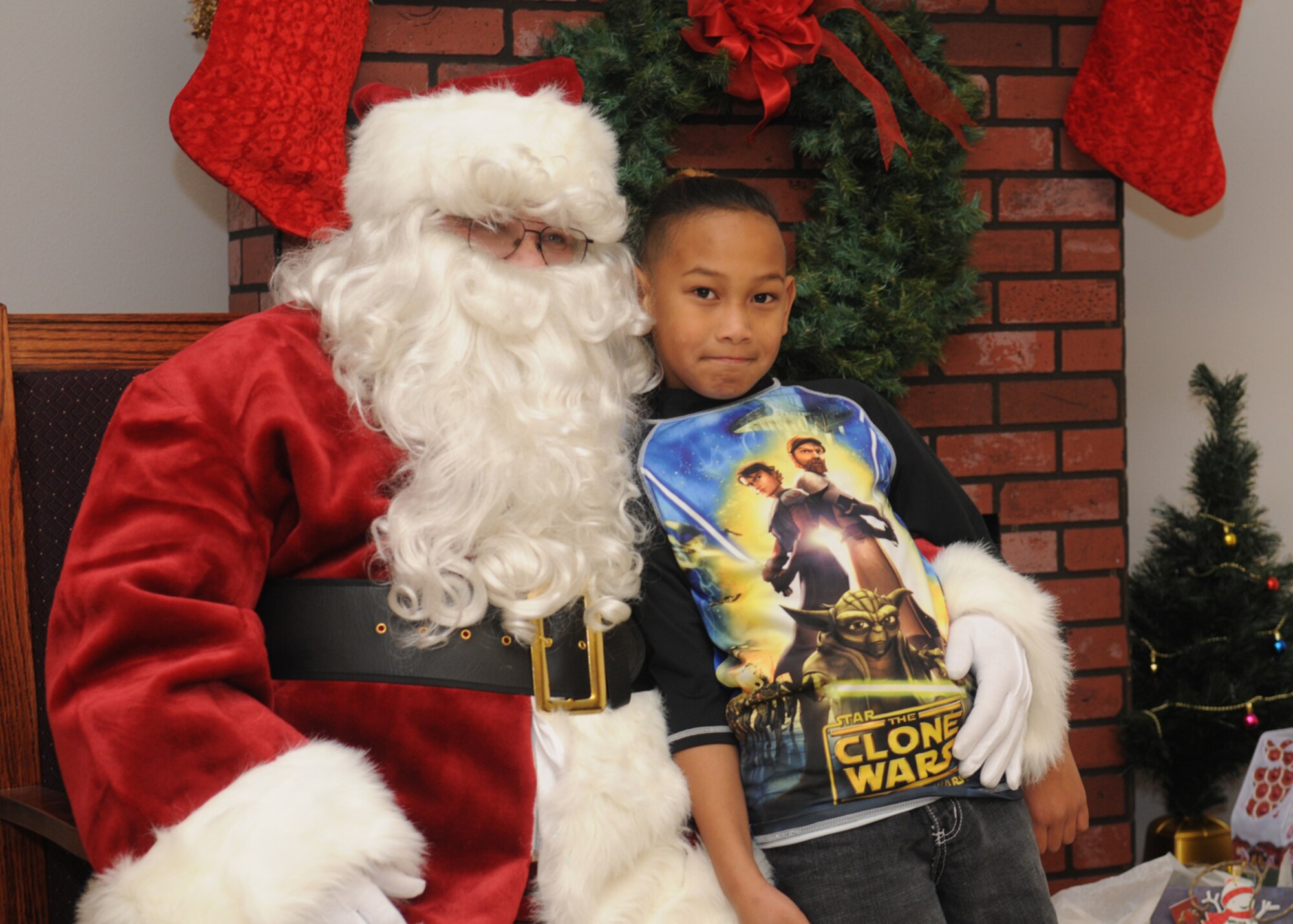 GOODFELLOW AIR FORCE BASE, Texas -- Richard Kosaka, Jr., son of Richard Kosaka, 17th Logistics Readiness Squadron, gets his photo taken with Santa Claus after the tree lighting ceremony, Dec. 7, 2009. Anyone who had their picture taken with Santa received a Polaroid to take home. (U.S. Air Force photo/Airman Clayton Lenhardt)