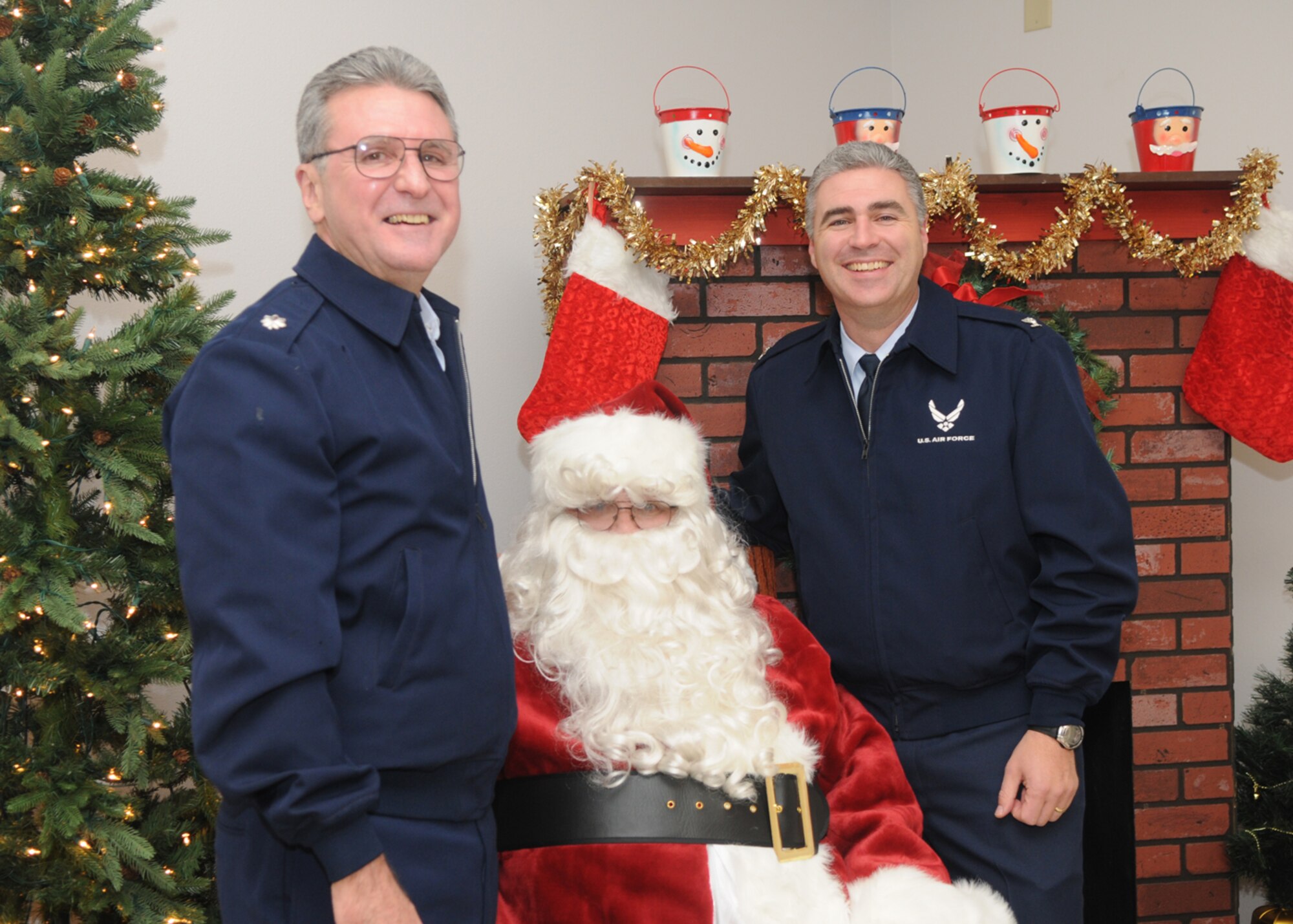 GOODFELLOW AIR FORCE BASE, Texas -- Chaplain (Lt. Col.) Kevin Cody, 17th Training Wing chaplain, and Col. Thomas Geary, 17th TRW commander, get their photo taken with Santa Claus after the annual tree lighting ceremony, Dec. 7, 2009. Anyone who had their picture taken with Santa received a Polaroid to take home. (U.S. Air Force photo/Airman Clayton Lenhardt)