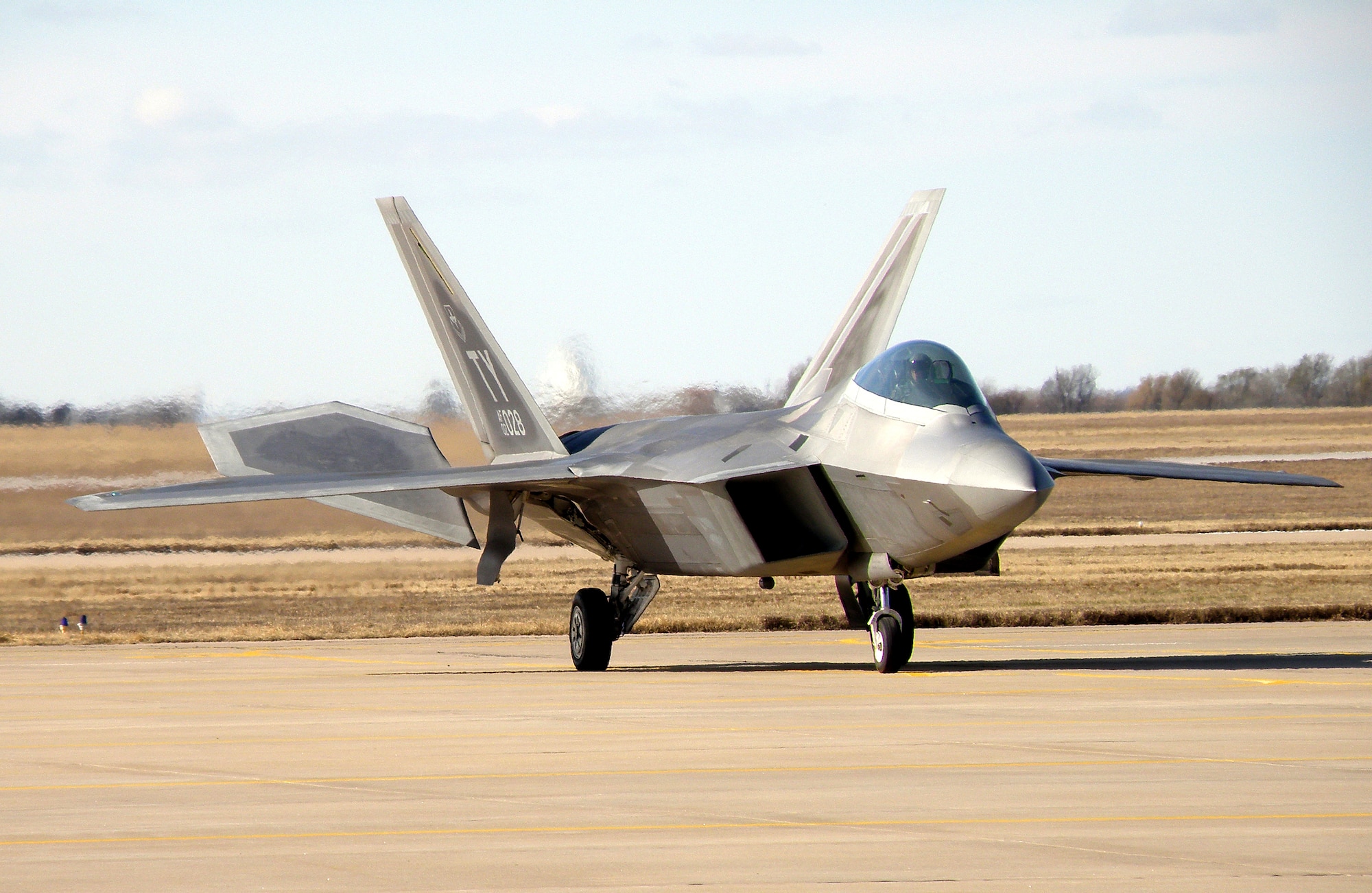 An F-22 Raptor from Tyndall AFB, Fla., lands at Vance, Dec. 3, for refueling. While the aircraft was on base, Team Vance members got a close-up look at the Air Force’s newest fighter aircraft. (U.S. Air Force photo/ Kyle Osborn)