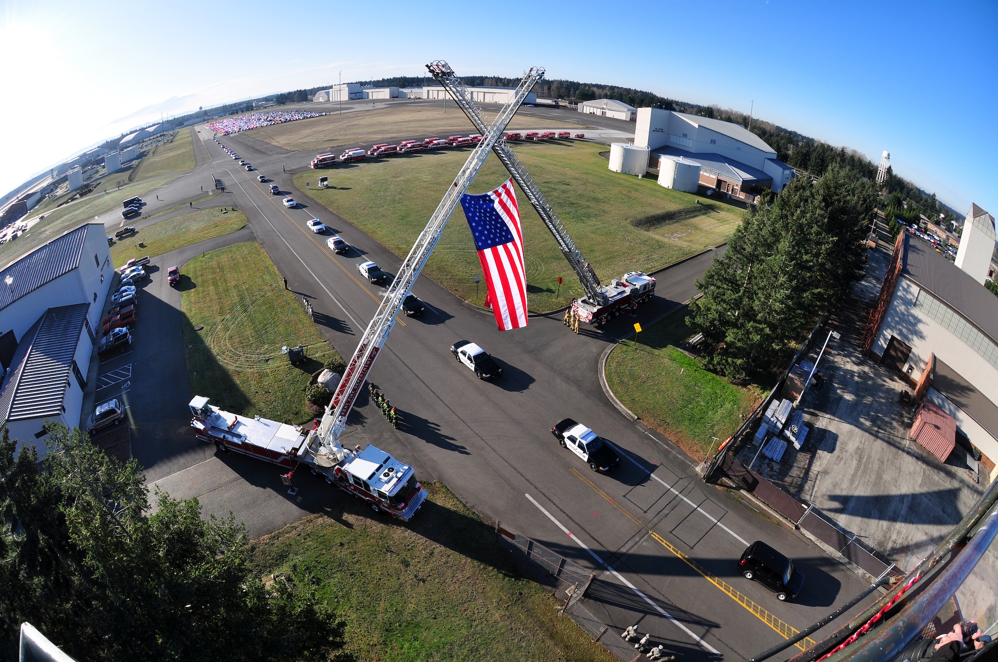Approximately 2,000 emergency services vehicles from throughout the U.S. and Canada depart McChord Air Force Base Dec. 8 in a procession to the Tacoma Dome Memorial Service honoring four fallen Lakewood, Wash., Police Officers.  McChord Airmen provided a staging area for emergency responders and their vehicles and honored the Lakewood Police Officers by lining the streets of the installation procession route. (U.S. Air Force Photo/Staff Sgt. Robert Tingle)