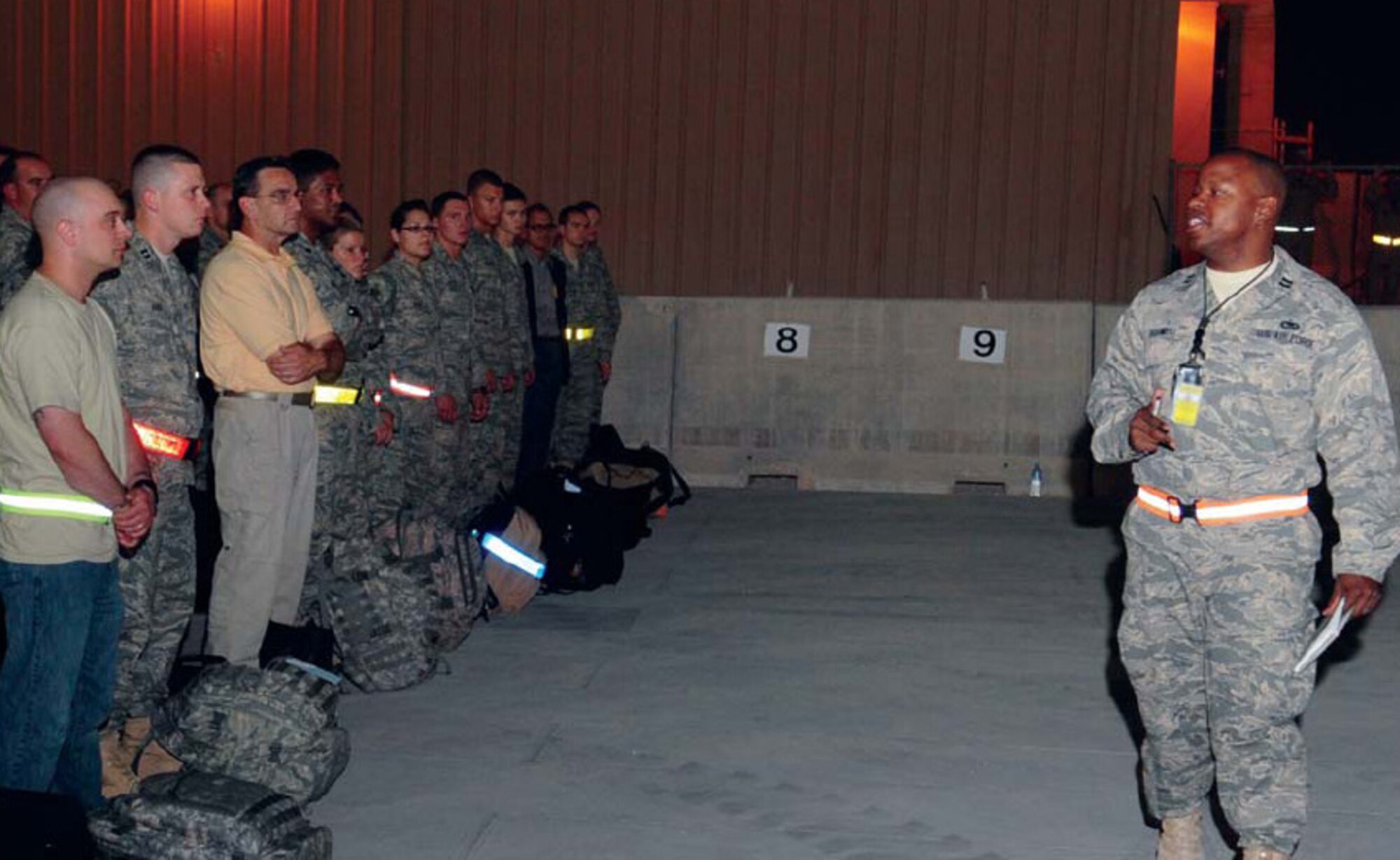 Capt. Michael Boswell, currently deployed to Southwest Asia to the 379th Expeditionary Logistics Readiness Squadron as the Deployment and Distribution Flight commander and installation deployment officer from the 509th Logistics Readiness Squadron here, briefs new arrivals at his deployed location recently. (U.S. Air Force courtesy photo)