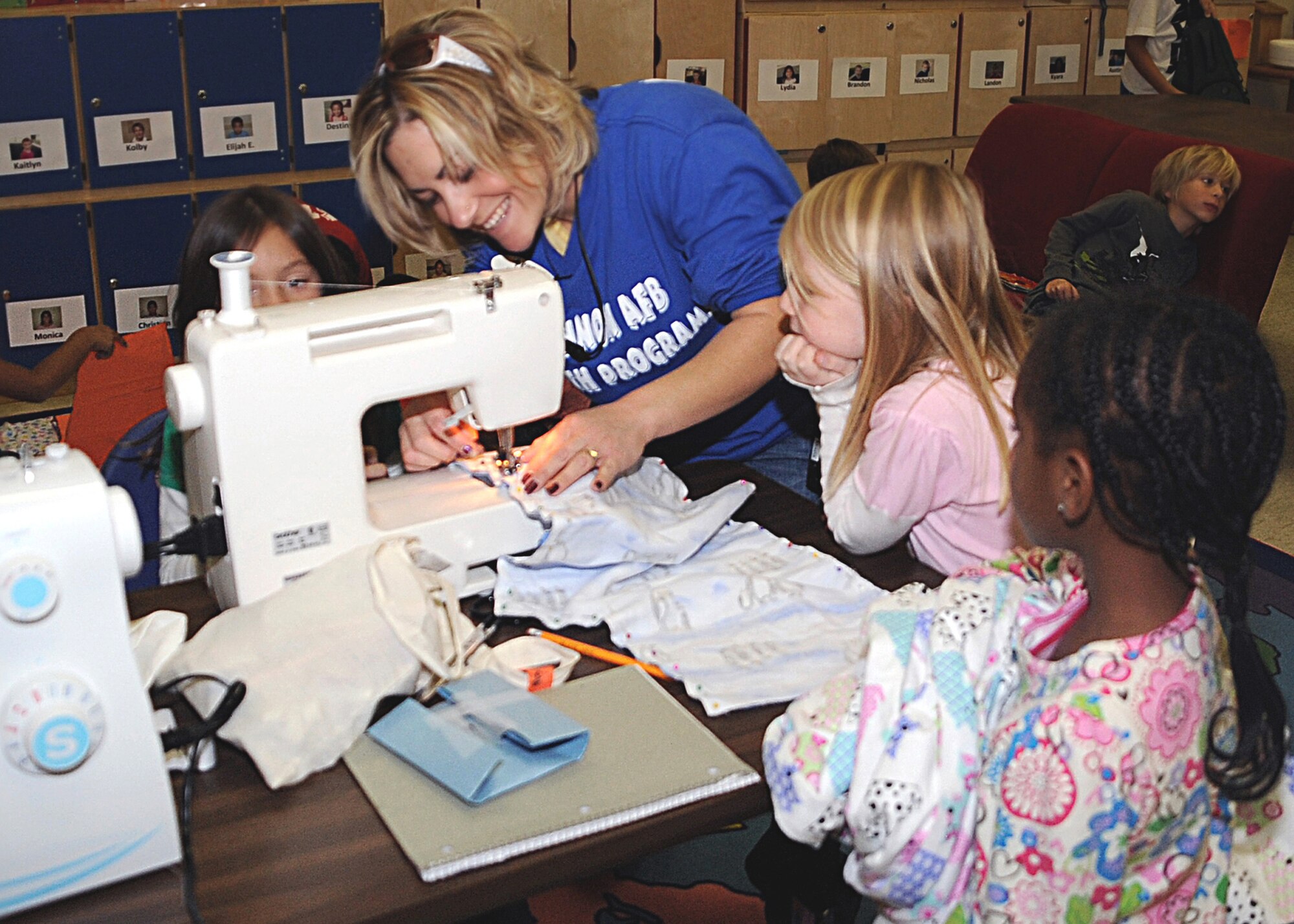 CANNON AIR FORCE BASE, N.M.-- Maria Lugaro, a School Age Program assistant,  teaches children how to make holiday pajama pants Dec. 2. The program received 5-star accrediation by the National Afterschool Association, and is one of only eight accredited programs in New Mexico. (U.S. Air Force photo by Airman 1st Class Maynelinne De La Cruz)