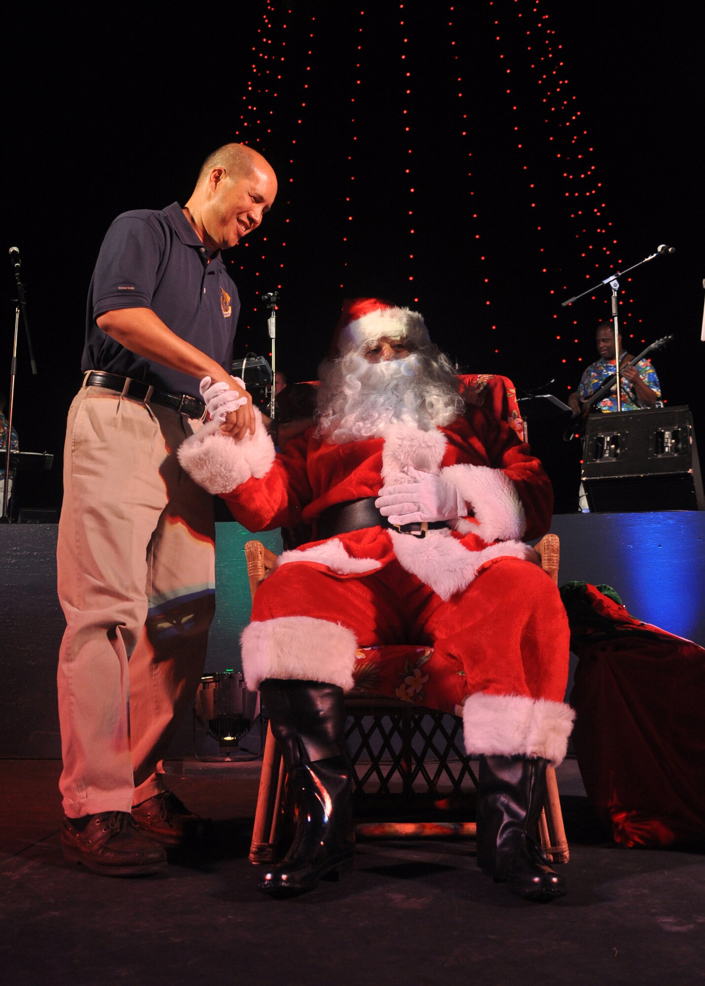 HICKAM AIR FORCE BASE, Hawaii -- Col. Giovanni Tuck, 15th Airlift Wing commander, visits with Santa Claus during the Freedom Tower lighting ceremony Dec, 4. More than 5,000 multi-colored twinkle lights make the tower Oahu?s largest Christmas tree at 171 feet tall. This year marked the 40th anniversary of the freedom tower lighting. Hickam's history reports that it was spared from the Japanese attack on Dec. 7, 1941 because they believed the majestic tower was our place of worship. The tower stored 500,000 gallons of emergency water for the base. (U.S. Air Force photo/Staff Sgt. Mike Meares)