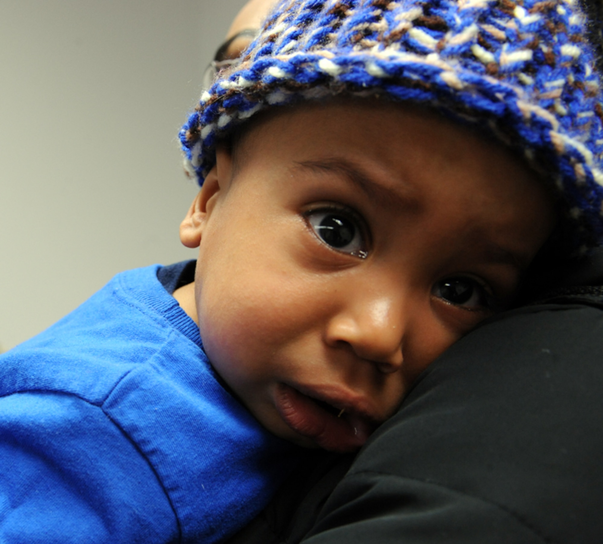 ELLSWORTH AIR FORCE BASE, S.D. -- One-year-old Azzan Alexander is held by his mother Genevieve Alexander after he received shots, Dec. 8. Azzan received a diphtheria and tetanus shot to his upper thigh. (U.S. Air Force photo/Airman 1st Class Adam Grant)