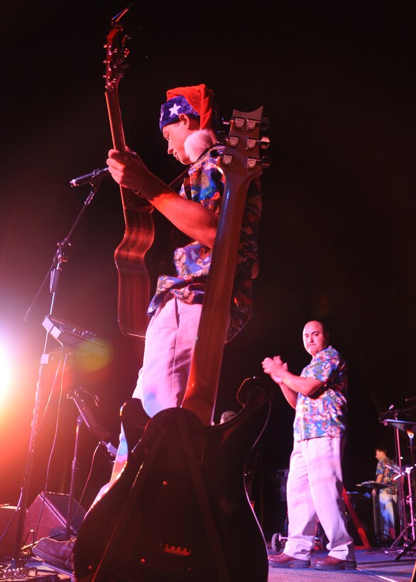 HICKAM AIR FORCE BASE, Hawaii -- Staff Sgt. John Kukan, a musician with Hana Hou, U.S. Air Force Band of the Pacific - Hawaii, performs holiday music during the Freedom Tower Lighting celebration Dec. 4. More than 5,000 multi-colored twinkle lights make the tower Oahu's largest Christmas tree at 171 feet tall. This year marked the 40th anniversary of the freedom tower lighting. Hickam's history reports that it was spared from the Japanese attack on Dec. 7, 1941 because they believed the majestic tower was our place of worship. The tower stored 500,000 gallons of emergency water for the base. (U.S. Air Force photo/Staff Sgt. Mike Meares)