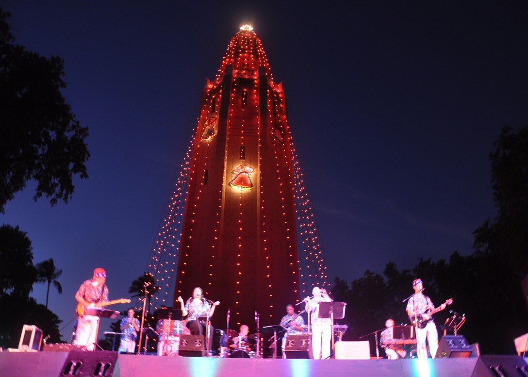 HICKAM AIR FORCE BASE, Hawaii -- Hana Hou, Pacific Air Forces Band - Hawaii, performs holiday music during the Freedom Tower Lighting celebration Dec. 4. More than 5,000 multi-colored twinkle lights make the tower Oahu's largest Christmas tree at 171 feet tall. This year marked the 40th anniversary of the freedom tower lighting. Hickam's history reports that it was spared from the Japanese attack on Dec. 7, 1941 because they believed the majestic tower was our place of worship. The tower stored 500,000 gallons of emergency water for the base. (U.S. Air Force photo/Staff Sgt. Mike Meares)