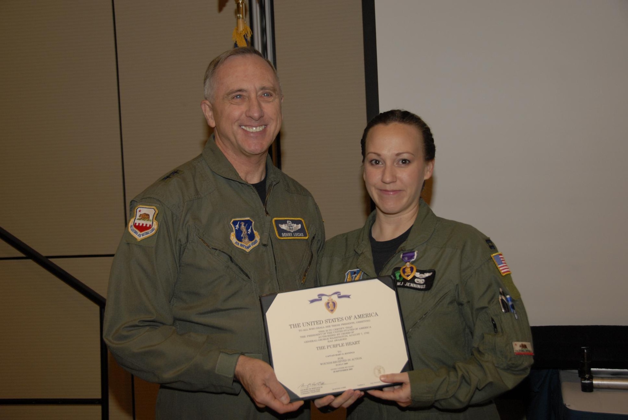 Capt. Mary O. Jennings, 129th Rescue Wing HH-60G Pave Hawk co-pilot, receives the Purple Heart from California Air National Guard Commander, Maj. Gen. Dennis G. Lucas, during an awards ceremony Dec. 6, 2009. Captain Jennings was the recipient of the Purple Heart due to injuries sustained in a July 29, 2009 Afghanistan rescue mission. (Air National Guard photo by Staff Sgt. Kim Ramirez)
