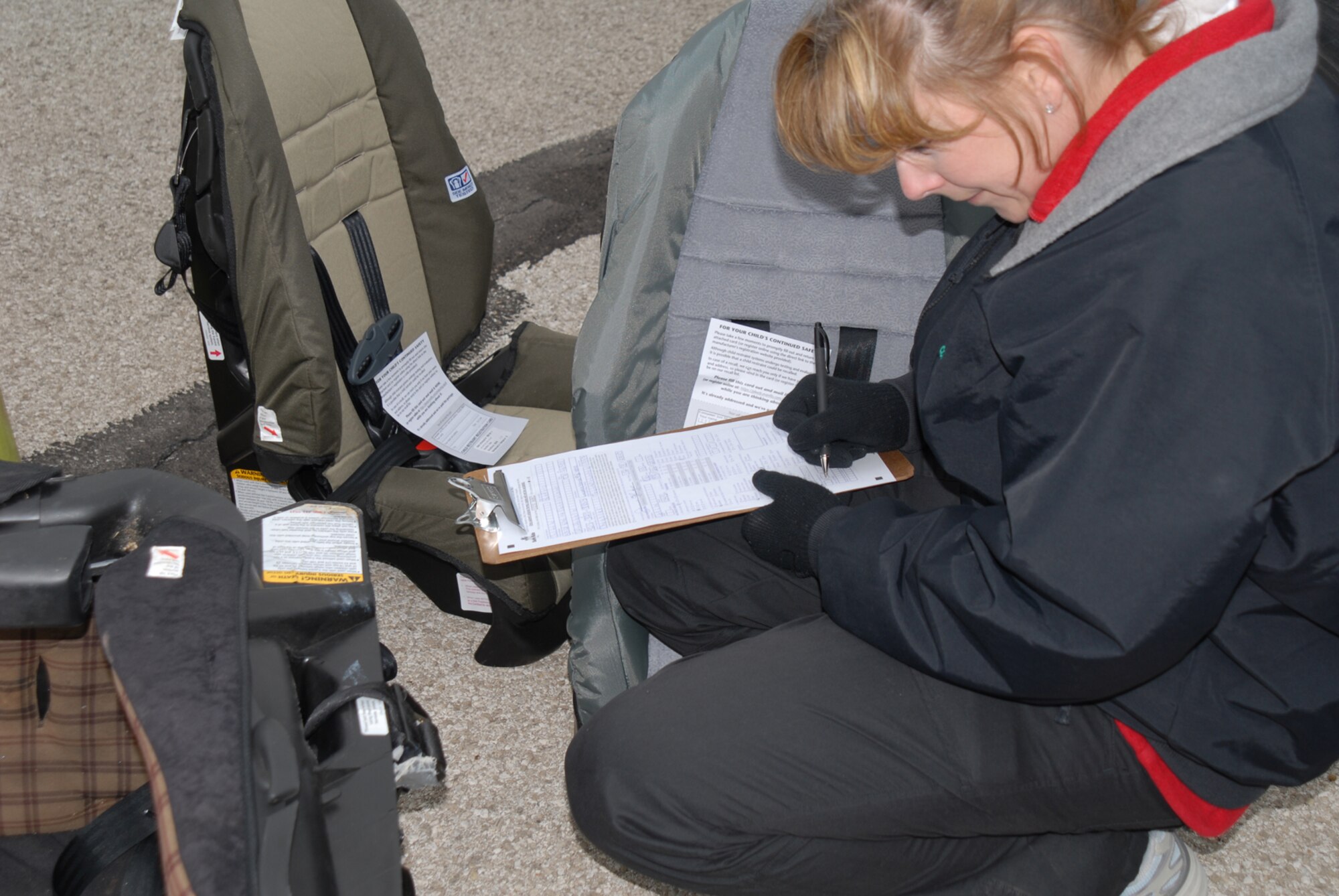 GOODFELLOW AIR FORCE BASE, Texas -- Leisa Lloyd, 17th Medical Operations Squadron, takes down information about an old car seat during the child safety seat workshop, Dec. 3, 2009. The workshop ensured Goodfellow members children's car seats meet safety requirements and were properly installed. (U.S. Air Force photo/Staff Sgt. Laura R. McFarlane)