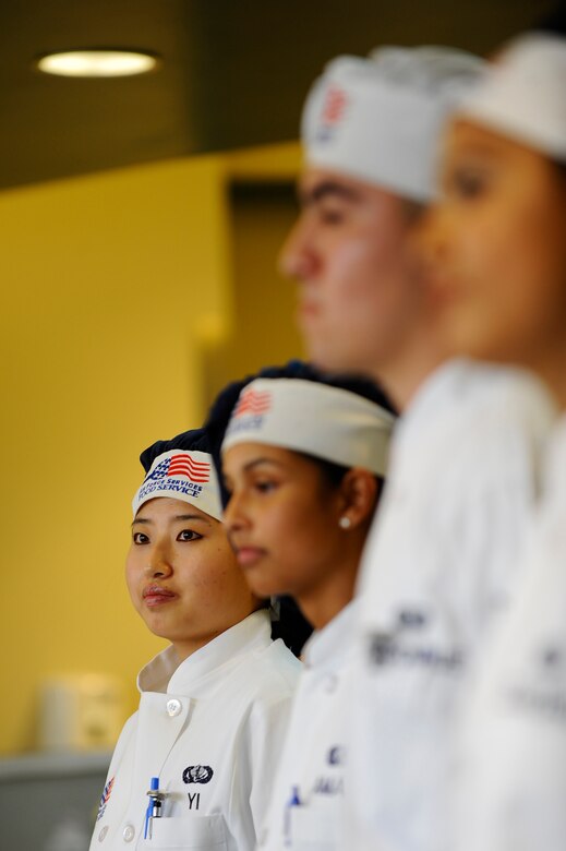 Senior Airman Eun Yi, 1st Special Operations Force Support Squadron food service specialist, waits to hear the results of the quarterly Top Chef competition Dec. 3 at Hurlburt Field. Airman Yi prepared bulgogi which is a traditional Korean dish of beef, broccoli and rice. (Air Force photo by Senior Airman Julianne Showalter)