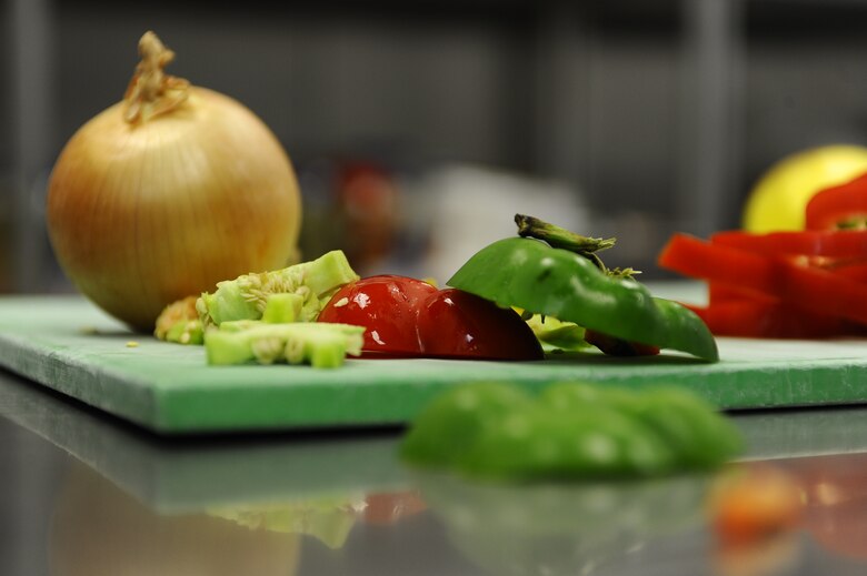 Four food service specialists assigned to the 1st Special Operations Force Support Squadron participated in the quarterly Top Chef competition testing their skills as cooks Dec. 3 at Hurlburt Field. The dishes prepared were judged on taste, originality, presentation and creativity. (Air Force photo by Senior Airman Julianne Showalter)