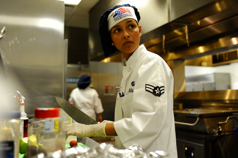 Airman 1st Class Nadia Amaya, 1st Special Operations Force Support Squadron food service specialist, checks the clock during the quarterly Top Chef competition Dec. 3 at Hurlburt Field. The cooks were allotted 90 minutes to prepare an entrée. (Air Force photo by Senior Airman Julianne Showalter)