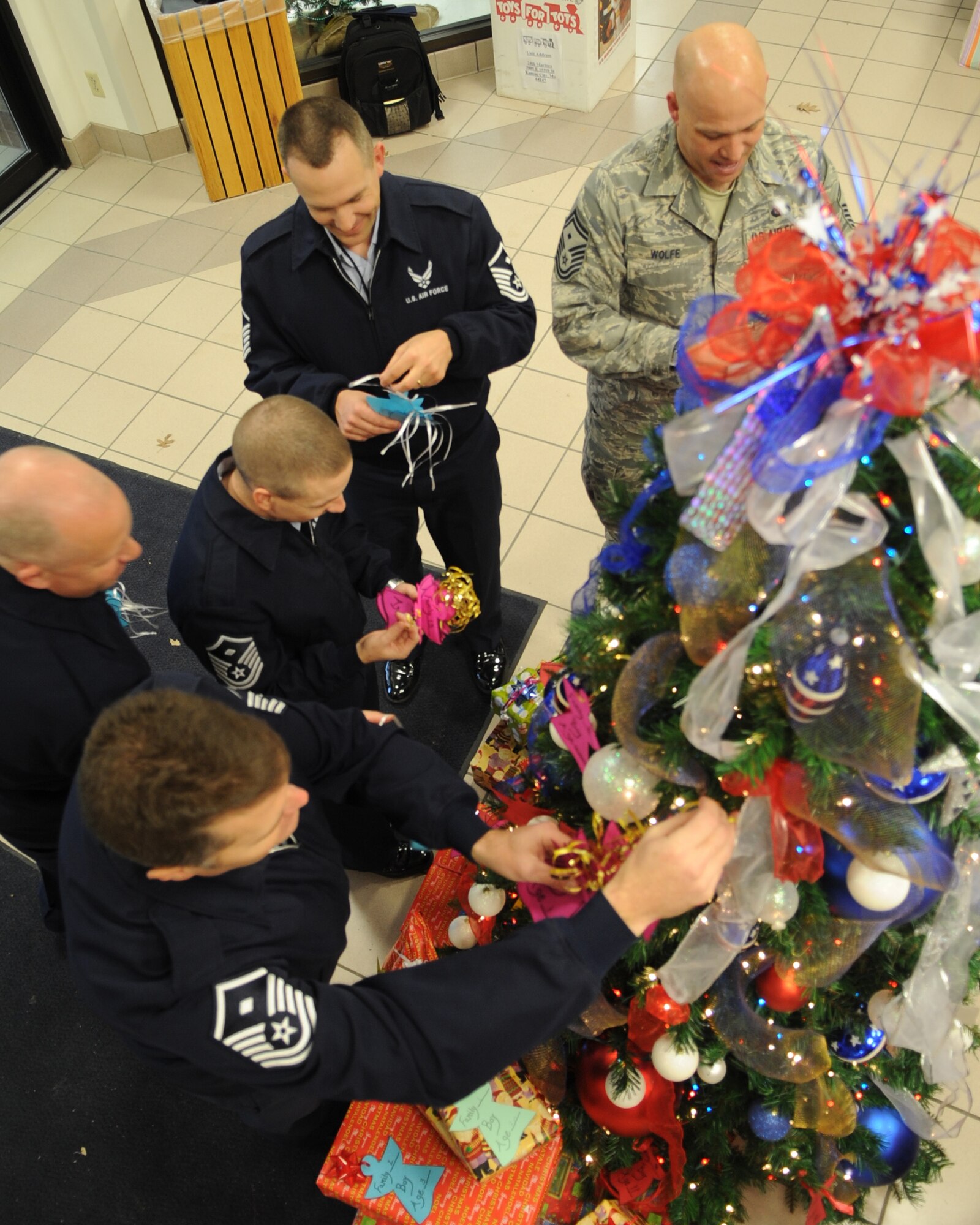 WHITEMAN AIR FORCE BASE, Mo. - Whiteman First Sergeants hang Angel Tree tickets on a holiday tree at the Base Exchange here Dec. 7, 2009. The Angel Tree is a program, ran by the First Sergeants Group, where the public is able to donate a gift to a family in need.  (U.S. Air Force Photo/ Senior Airman Cory Todd) (Released)