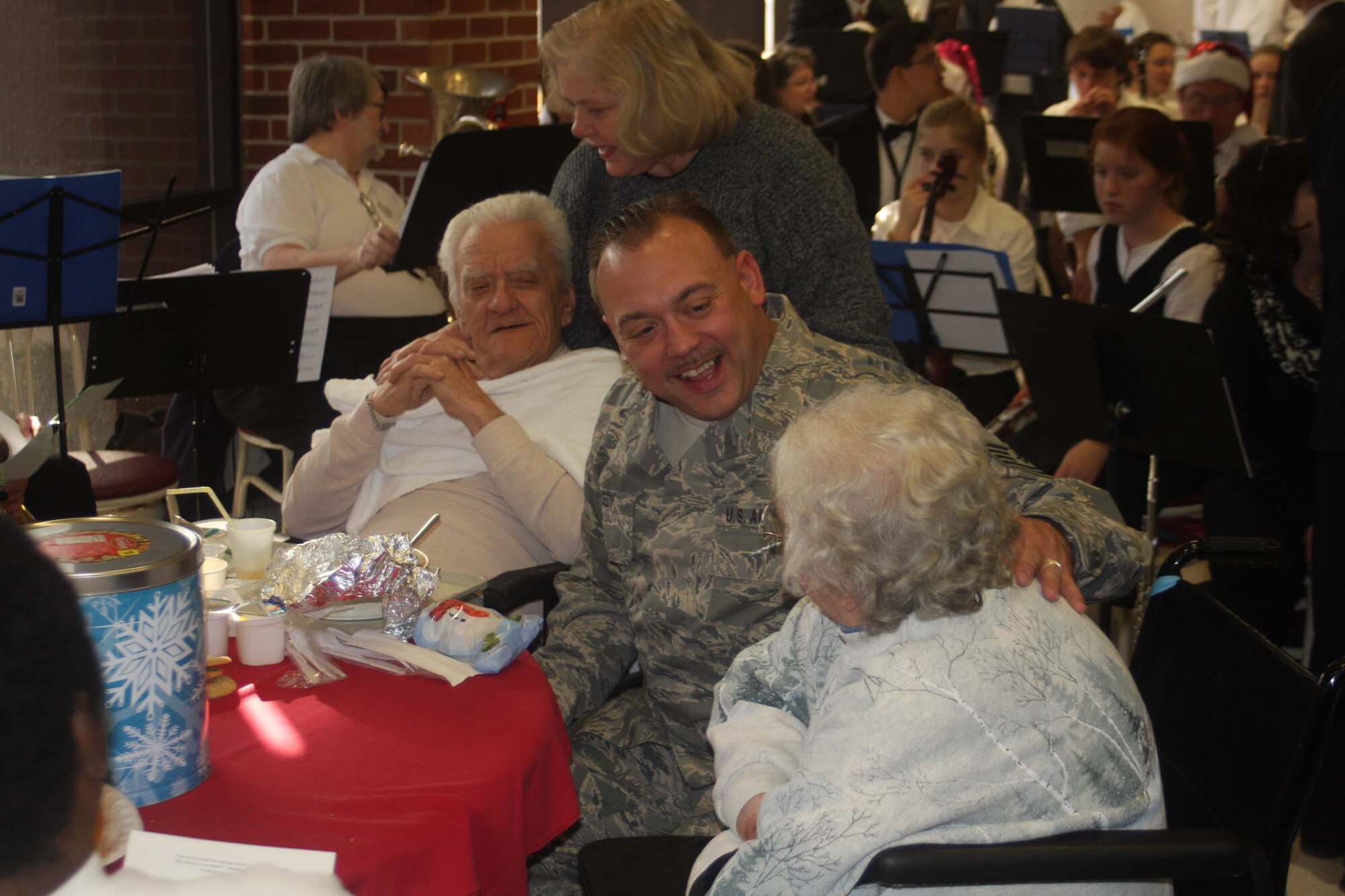 DAYTON, Ohio - Tech. Sgt. Timothy Leedy,445th Operations Support Squadron, enjoys time with veterans at the Dayton Veteran's Affairs Medical Center, Dec. 5.  Airmen of 445th Airlift Wing attend the annual Christmas party and provide gifts and companionship to local VA residents. (Air Force photo/Senior Airman Matthew Cook) 