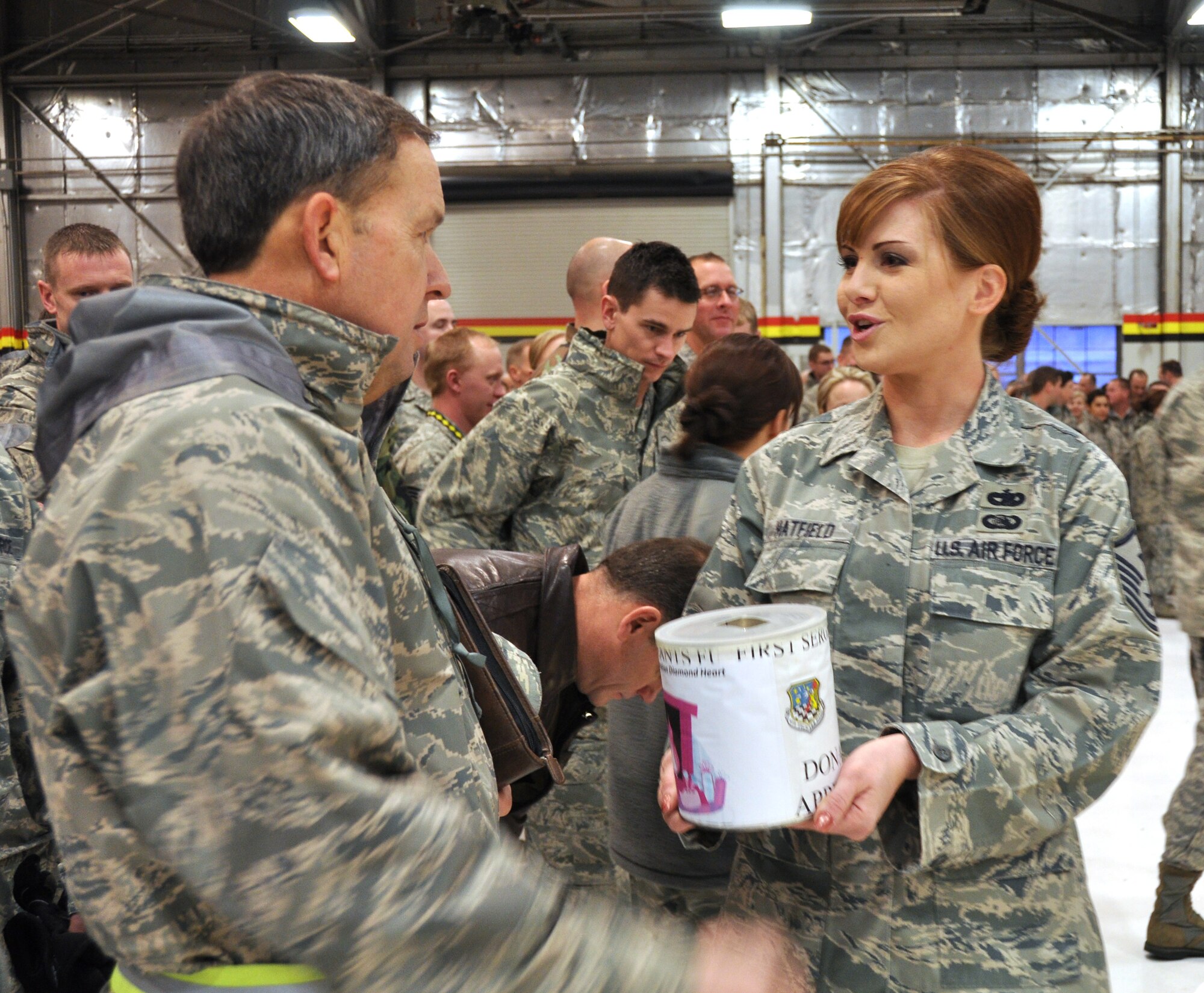 Master Sgt. Jodi Hatfield, 419th Communications Squadron first sergeant, collects donations to benefit Operation Diamond Heart during the December UTA commander’s call.  In just a few short minutes the first sergeants collected more than $1,500 to benefit needy Airmen and their families. (U.S. Air Force photo/Staff Sgt. Heather Skinkle)