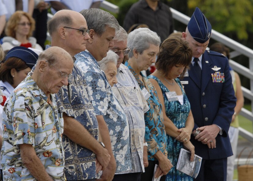 Survivors, family members and friends of the victims of the Dec. 7, 1941 attacks on Pearl Harbor and Hickam Air Field, pray during the invocation in a remembrance ceremony Dec. 7 at Hickam Air Force Base, Hawaii. The ceremony marked the 68th anniversary of the Japanese attack on Pearl Harbor and Hickam Air Field, and paid tribute the Airmen who were attacked and died on that tragic day. (U.S. Air Force photo/Tech. Sgt. Jerome S. Tayborn)