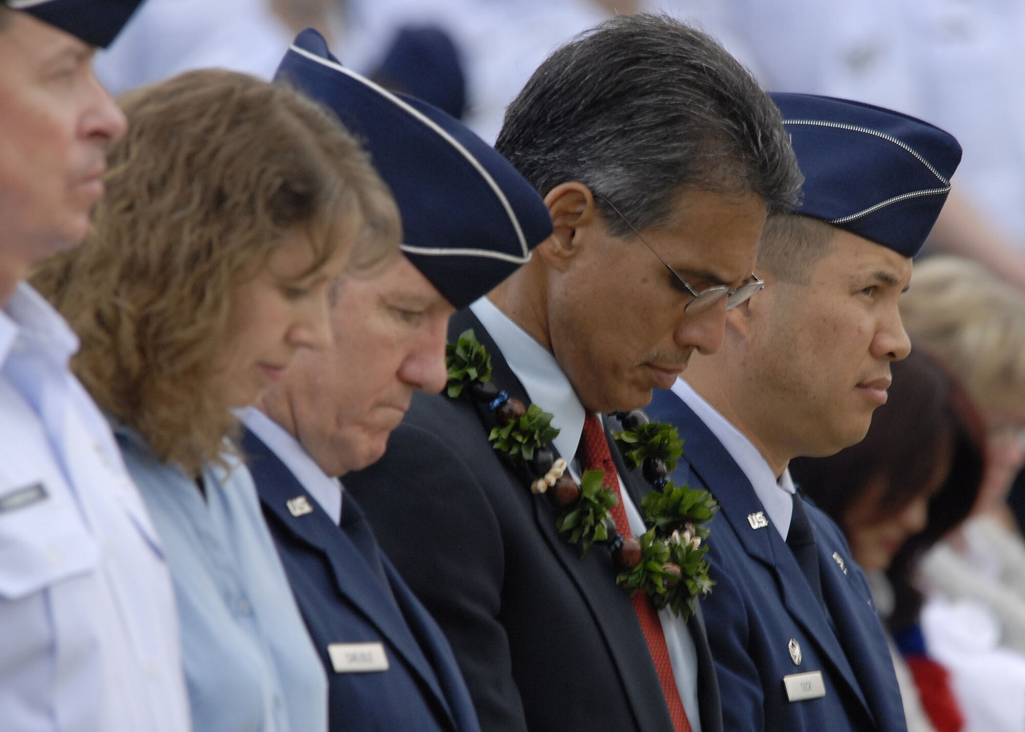Lt. Gen. “Hawk” Carlisle, 13th Air Force commander, James Aiona, Lt. Governor of Hawaii, and Col. Giovanni Tuck, 15th Air Wing commander, participate in an invocation during a remembrance Dec. 7 at Hickam Air Force Base, Hawaii.  The ceremony marked the 68th anniversary of the Japanese attack on Pearl Harbor and Hickam Air Field and paid tribute the Airmen who were attacked on that tragic day. (U.S. Air Force photo/Tech. Sgt. Jerome S. Tayborn)