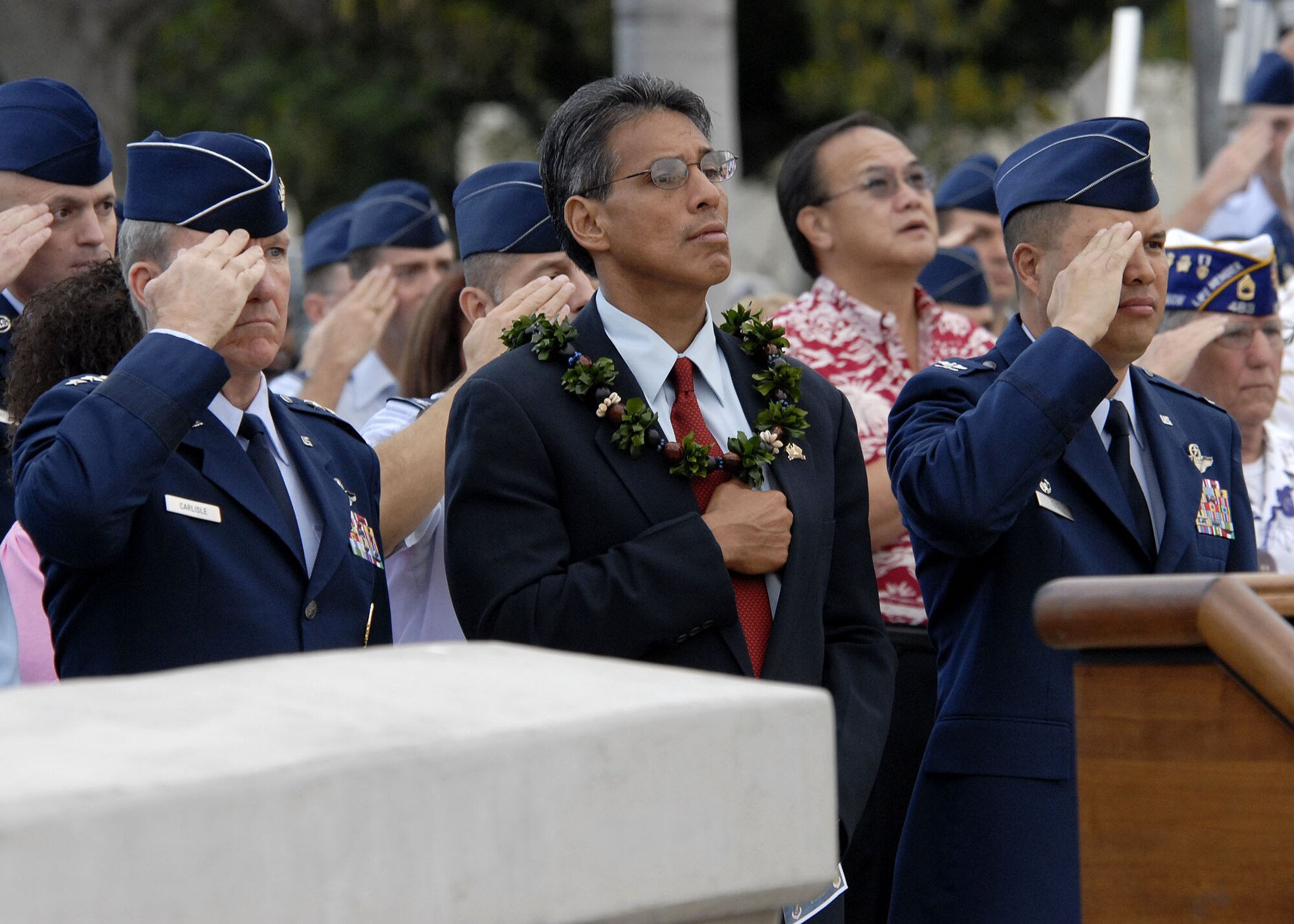 Lt. Gen. “Hawk” Carlisle, 13th Air Force commander, James Aiona, Lt. Governor of Hawaii, and Col. Giovanni Tuck, 15th Air Wing commander, salute and render respect during the singing of the national anthem in a remembrance Dec. 7 at Hickam Air Force Base, Hawaii.  The ceremony marked the 68th anniversary of the Japanese attack on Pearl Harbor and Hickam Air Field and paid tribute the Airmen who were attacked on that tragic day. (U.S. Air Force photo/Tech. Sgt. Jerome S. Tayborn)