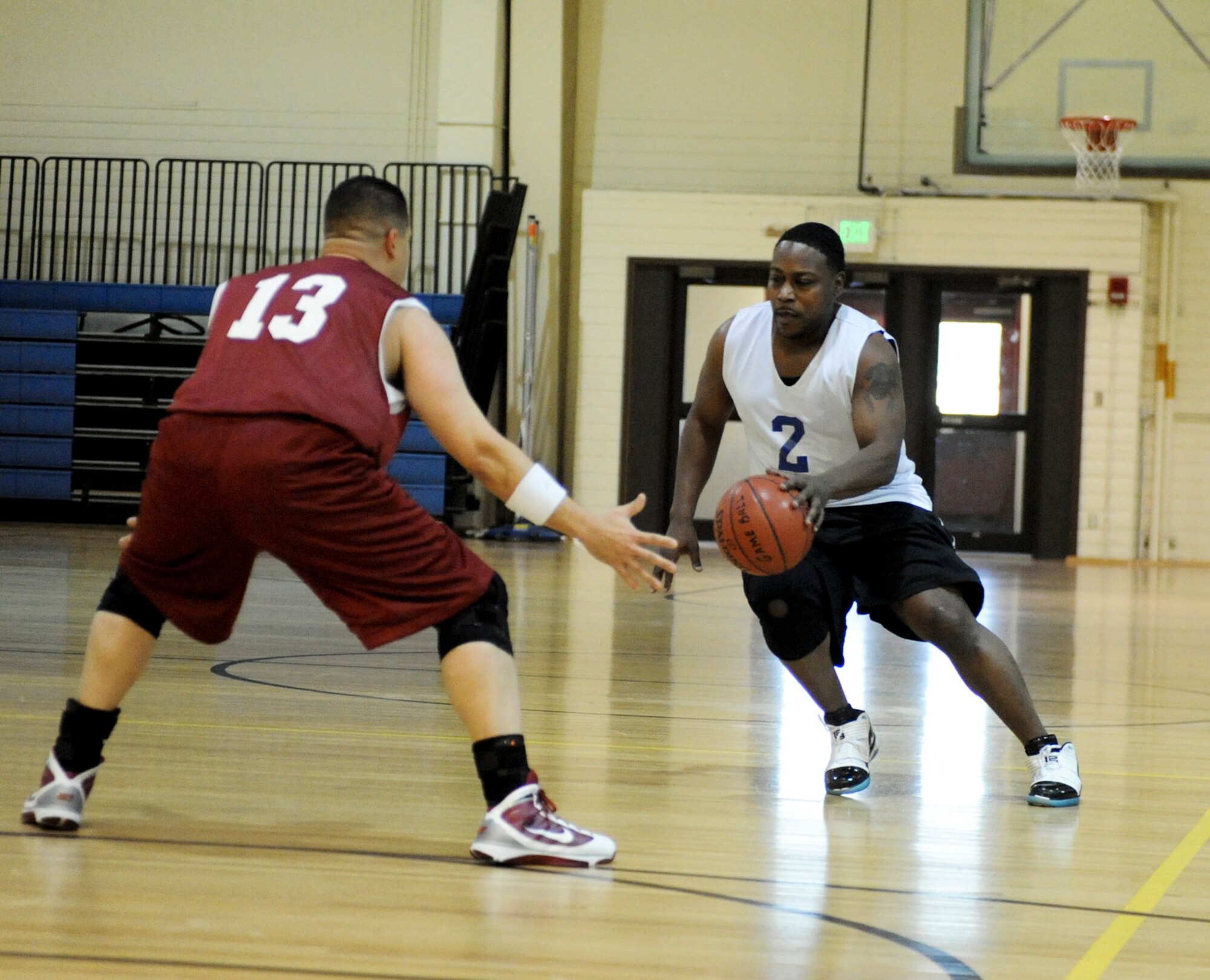 ELMENDORF AIR FORCE, Alaska -- The 381st Intelligence Squadron's Anthony Veasley attempts to drive past the 3rd Medical Support Squadron's James Anderson Dec. 7 at the Fitness Center. The 3rd MDSS came out strong going on a 19-0 run to start the opening minutes of the match. The 381st came back with their own scoring drive in the second half but still came up short with a score of 55-39. (U.S. Air Force photo/Airman 1st Class Christopher Gross)