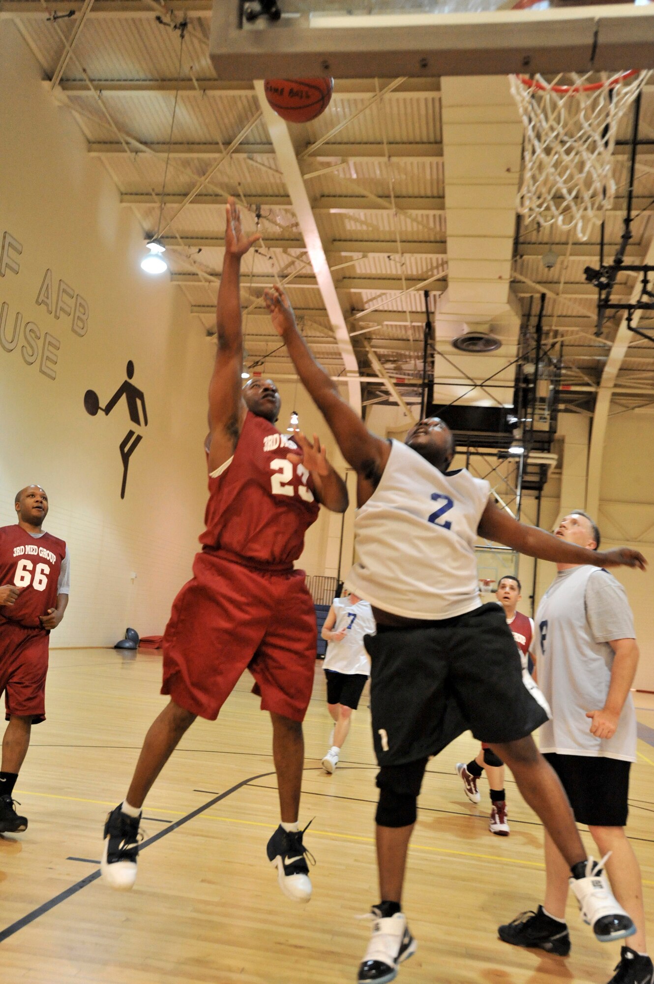 ELMENDORF AIR FORCE, Alaska -- The 3rd Medical Support Squadron's Kaleth Wright lays the ball up over the 381st Intelligence Squadron's Anthony Veasley Dec. 7 at the Fitness Center. The 3rd MDSS dominated a majority of the game and won with a score of 55-39.  (U.S. Air Force photo/Airman 1st Class Christopher Gross)