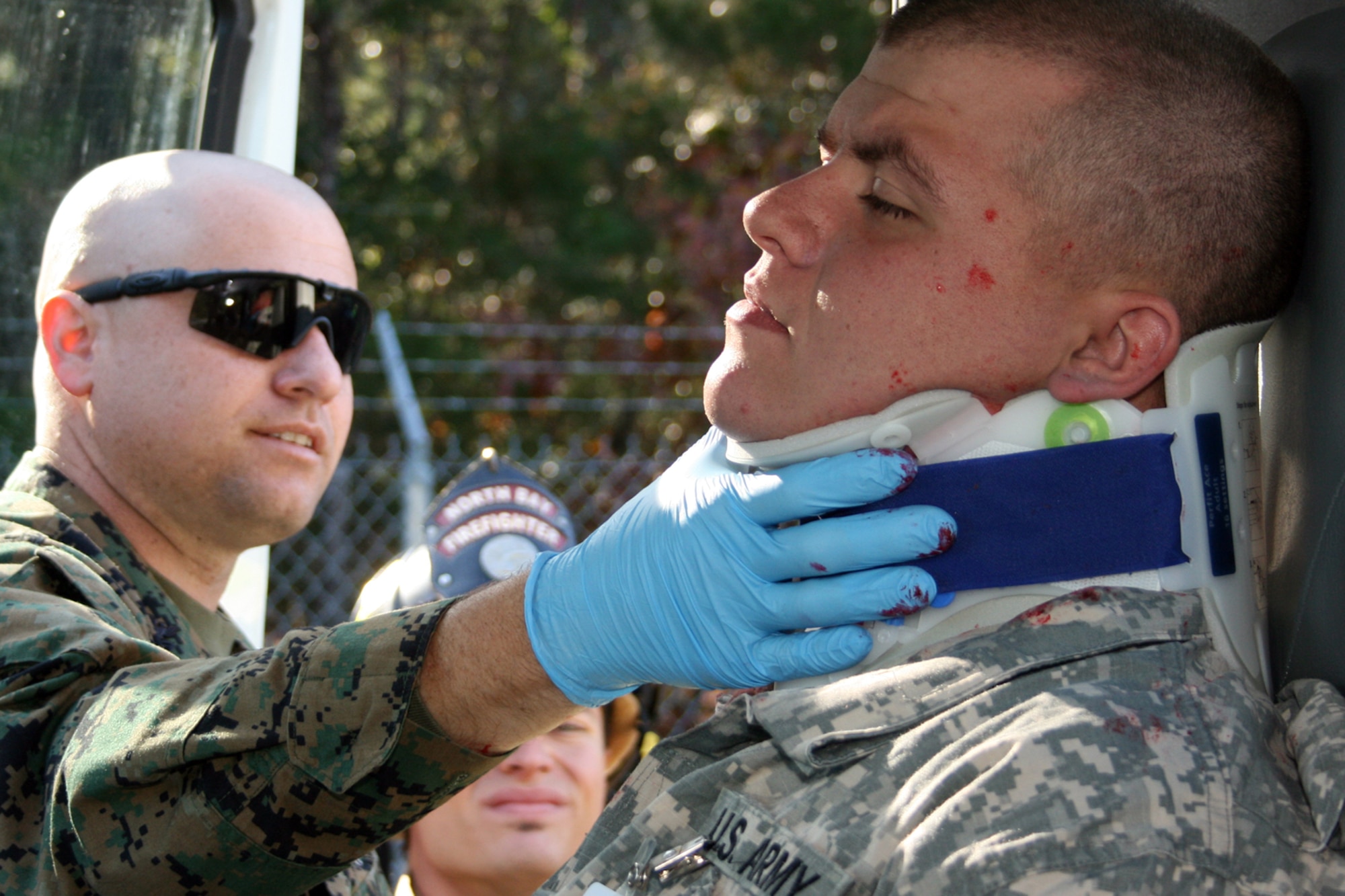 EGLIN AIR FORCE BASE, Fla. – A Marine Corps first responder secures a neck brace on an “injured victim” during a major accident response exercise, Dec. 7, at the Naval Explosive Ordnance Disposal School. The event simulated an accident where a truck carrying C-4 explosives careens into a bus filled with Soldiers. The NAVEOD School performs MAREs annually to examine how effective they can respond in the event of a catastrophe while communicating and working with outside emergency agencies. (U.S. Air Force photo/ 2nd Lt. Andrew Caulk)