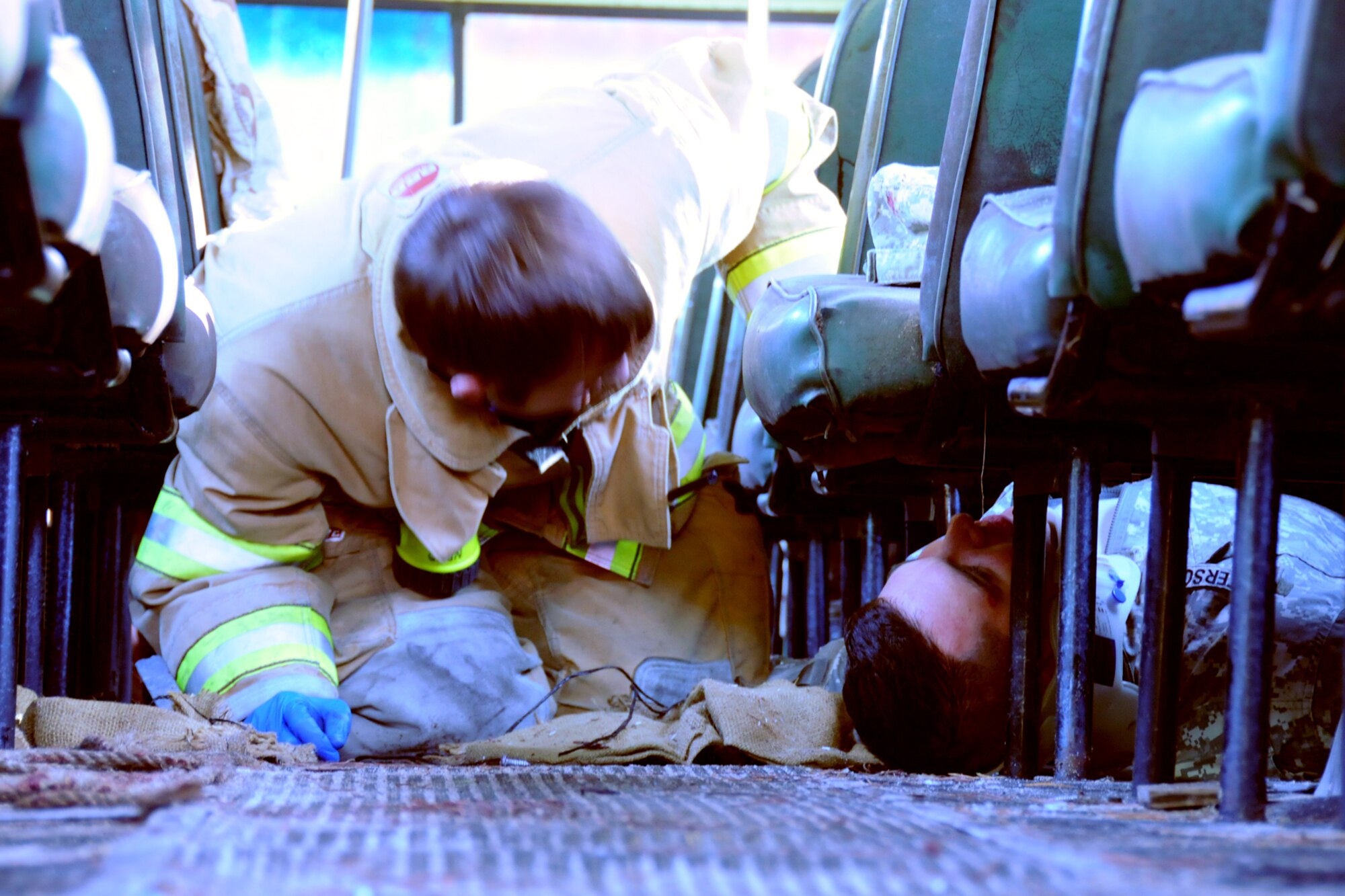 EGLIN AIR FORCE BASE, Fla. – A firefighter with the North Bay Fire Control District talks to a simulated victim trapped beneath a seat during a major accident response exercise, Dec. 7, at the Naval Explosive Ordnance Disposal School. The event simulated an accident where a truck carrying C-4 explosives careens into a bus filled with Soldiers. The NAVEOD School performs MAREs annually to examine how effective they can respond in the event of a catastrophe while communicating and working with outside emergency agencies. (U.S. Air Force photo/ Airman 1st Class Anthony Jennings)