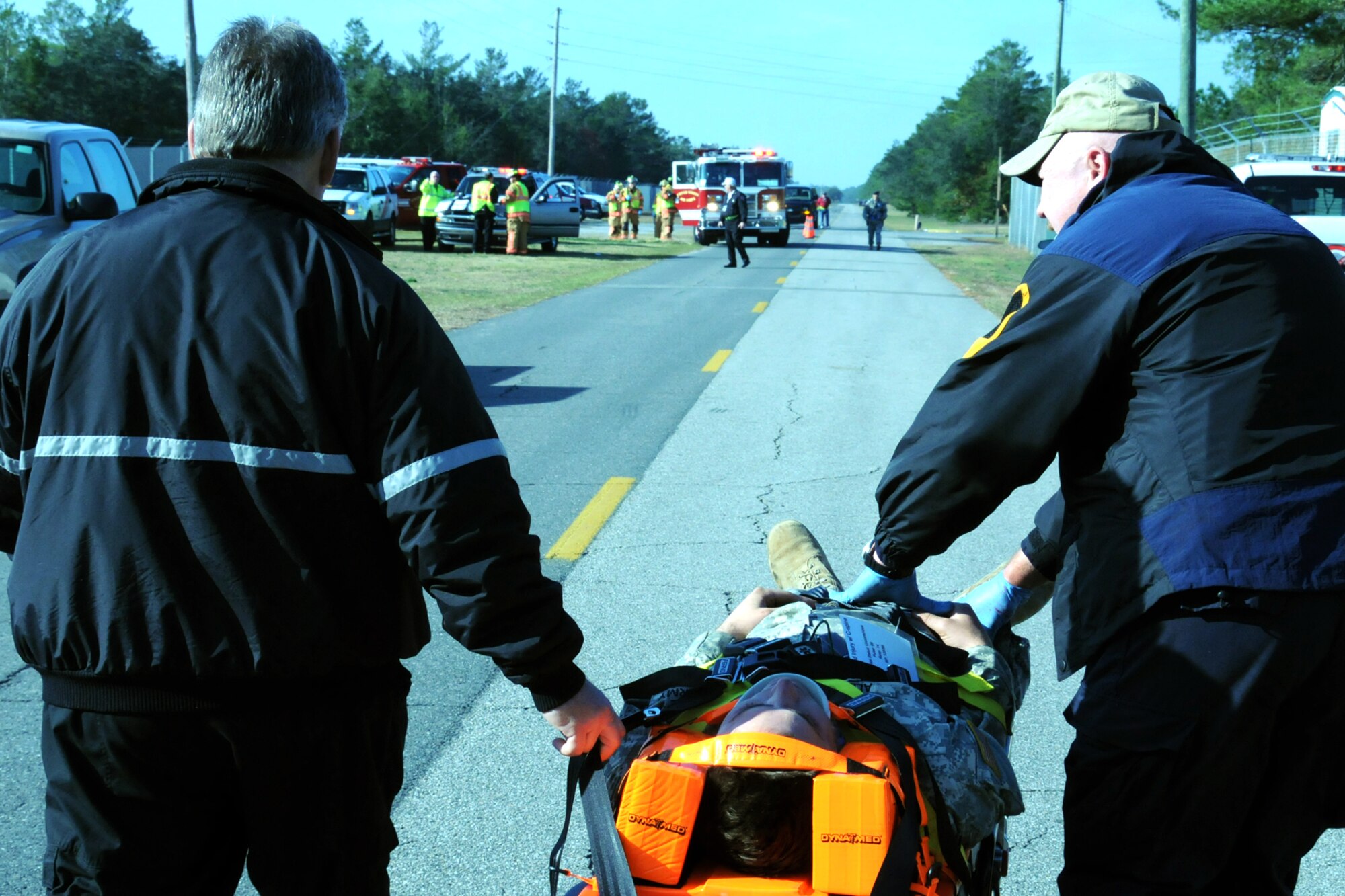 EGLIN AIR FORCE BASE, Fla. – Okaloosa Emergency Services rush an “injured victim” to a triage staging area during a major accident response exercise, Dec. 7, at the Naval Explosive Ordnance Disposal School. The event simulated an accident where a truck carrying C-4 explosives careens into a bus filled with soldiers. The NAVEOD School performs MAREs annually to examine how effective they can respond in the event of a catastrophe while communicating and working with outside emergency agencies. (U.S. Air Force photo/ Airman 1st Class Anthony Jennings)