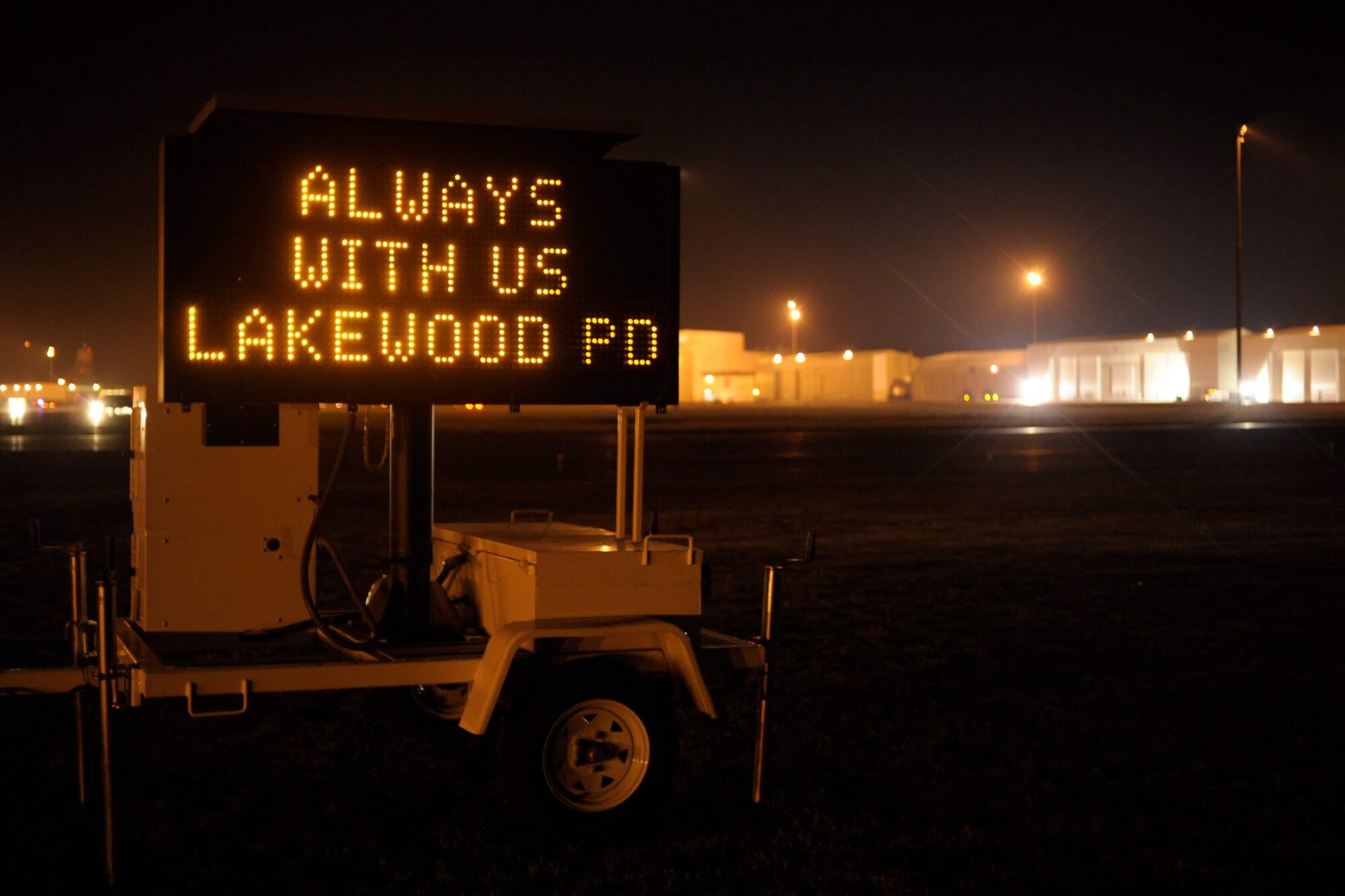 A marquee sign stands at the McChord north gate where approximately 2,000 emergency services vehicles from throughout the U.S. and Canada are staging their vehicles to depart McChord Dec. 8 in a procession to the Tacoma Dome Memorial Service honoring four fallen Lakewood, Wash., Police Officers. (U.S. Air Force photo/Abner Guzman)