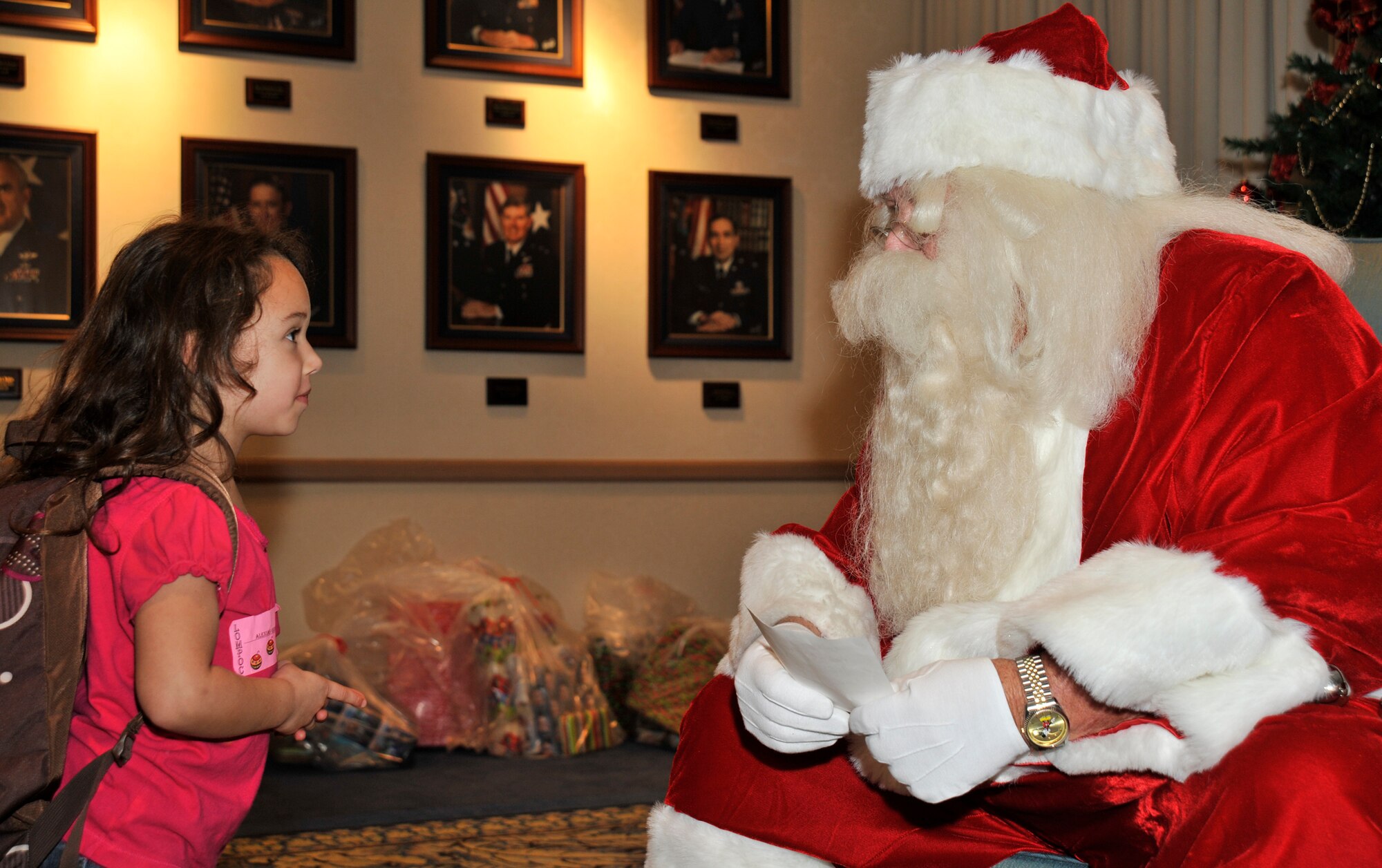 VANDENBERG AIR FORCE BASE, Calif. --  Alexias Garcia, from Lompoc, Calif., hands Santa Claus a letter, her escort help her write, letting him know what she wants for Christmas here Sat. Dec. 5, 2009. (U.S. Air Force photo/Senior Airman Stephanie Longoria)




























