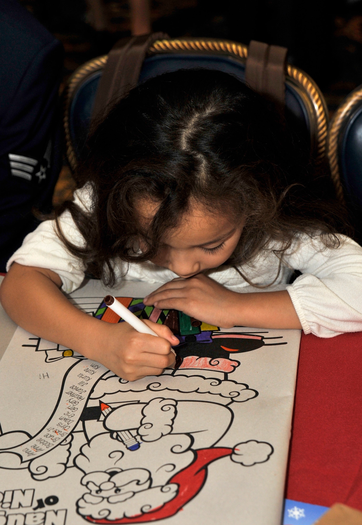 VANDENBERG AIR FORCE BASE, Calif. --Korina Jimenez colors a picture of Santa Claus during Operation Kids Christmas here Saturday, Dec. 5, 2009. Coloring books were given to for every child. (U.S. Air Force photo/Senior Airman Stephanie Longoria)

















