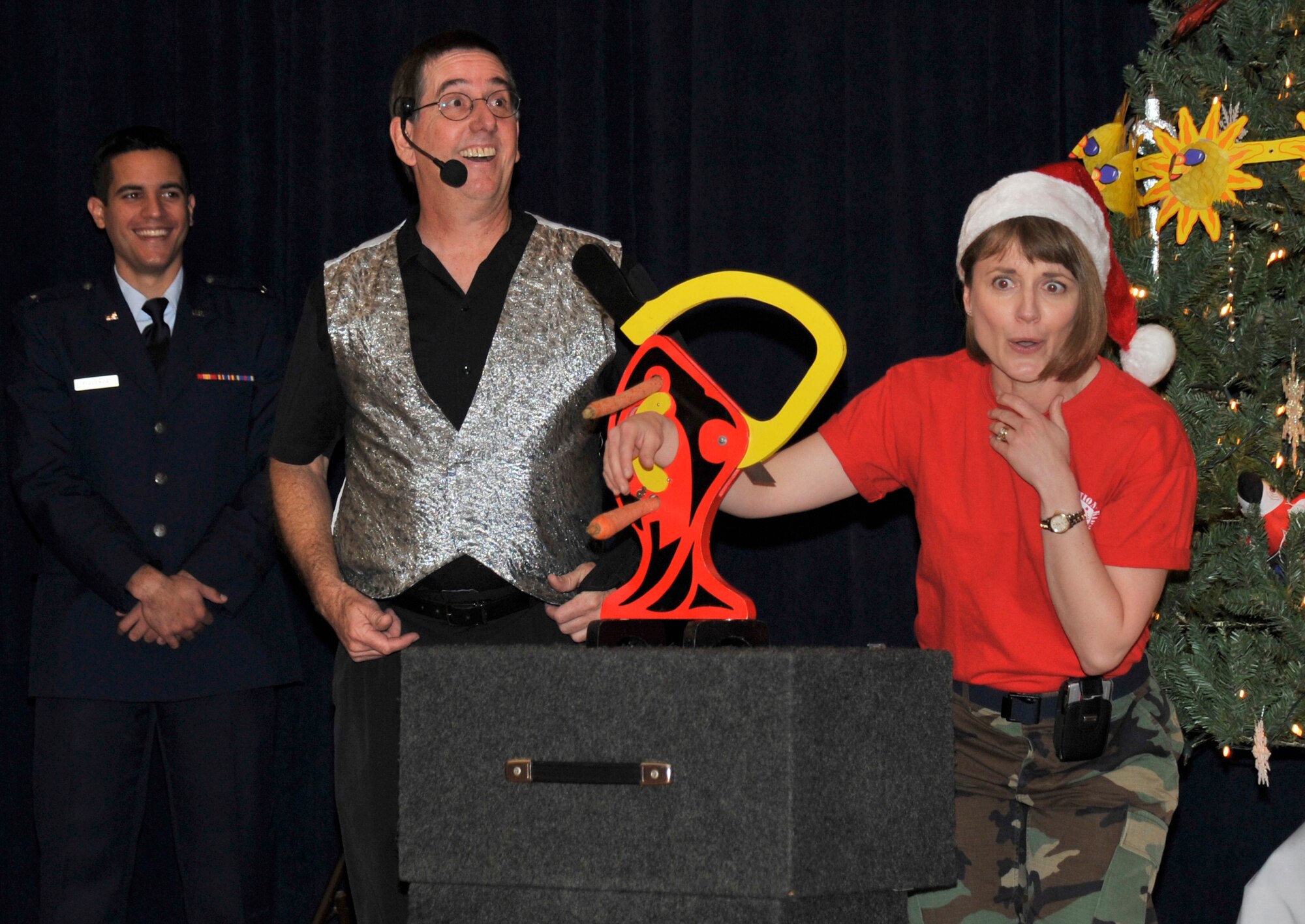 VANDENBERG AIR FORCE BASE, Calif. --  Lt. Col. Marne Deranger, the 392nd Training Squadron commander, assists magician Jim Wilson with a magic trick during Operation Kids Christmas here Saturday, Dec. 5, 2009. The event is an annual holiday party in support of  local underprivileged children. (U.S. Air Force photo/Senior Airman Stephanie Longoria)












